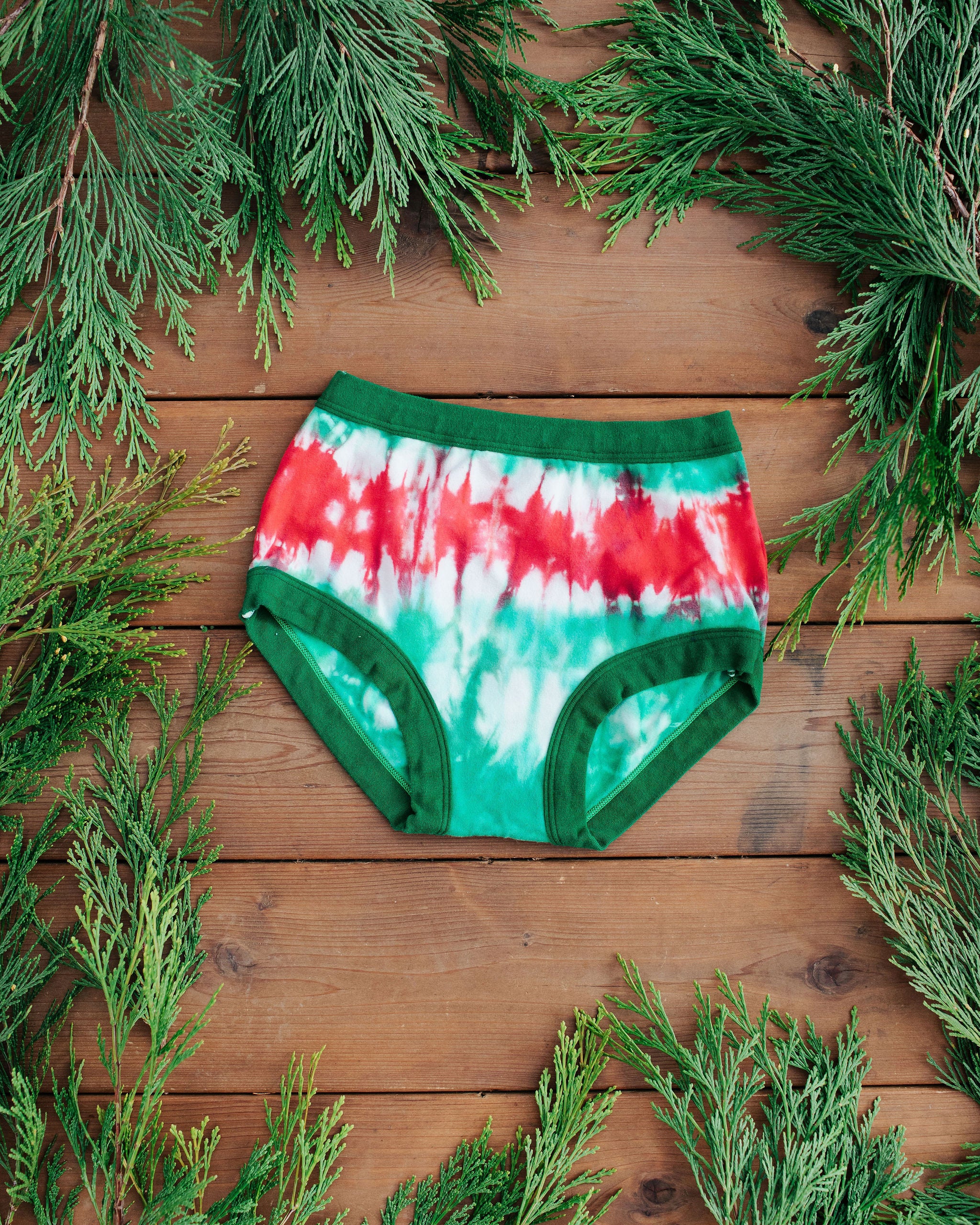 Flat lay of Thunderpants Original style underwear in Holiday Dye - red and green tie dye with green binding. 