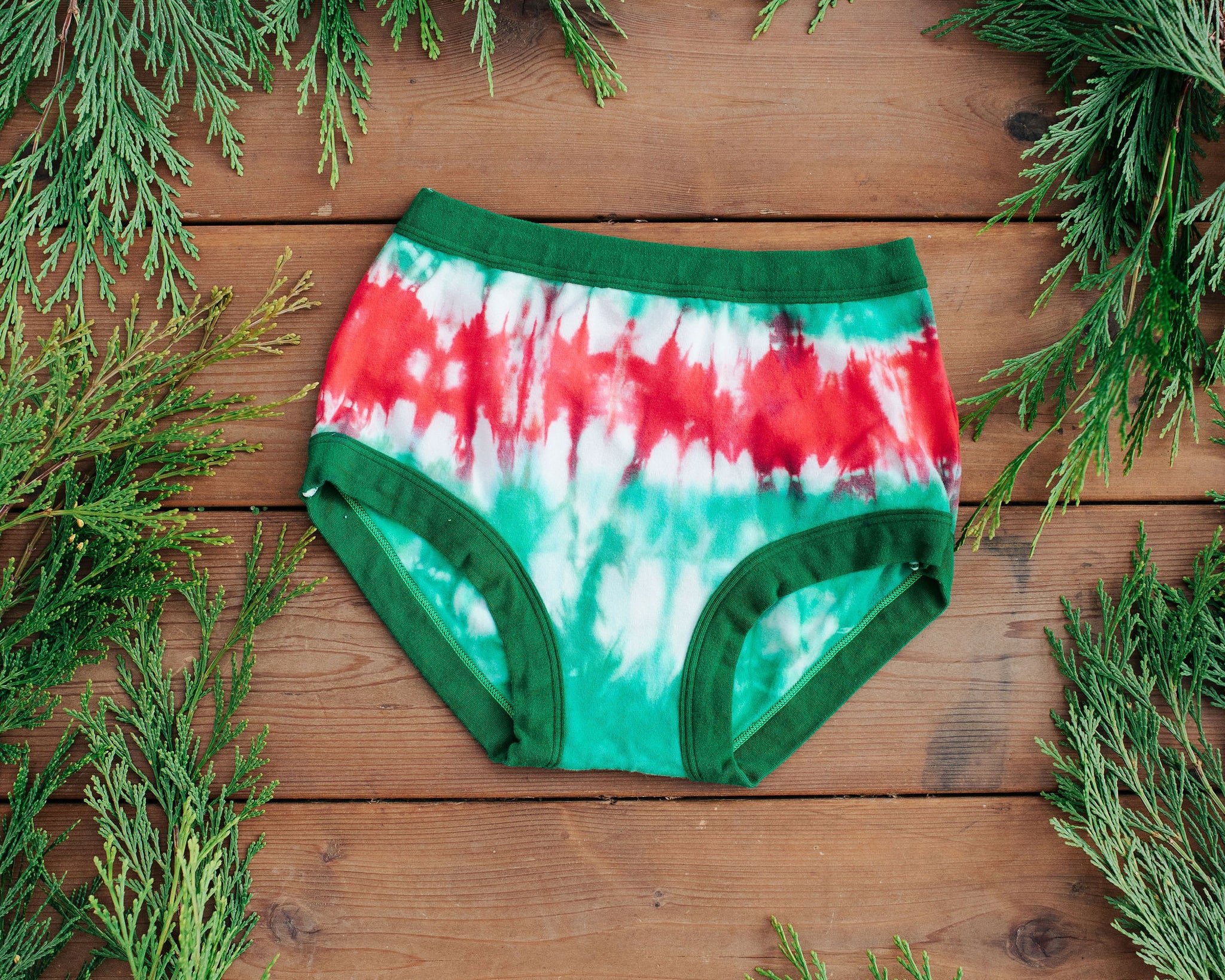 Flat lay of Thunderpants Original style underwear in Holiday Dye - red and green tie dye with green binding. 