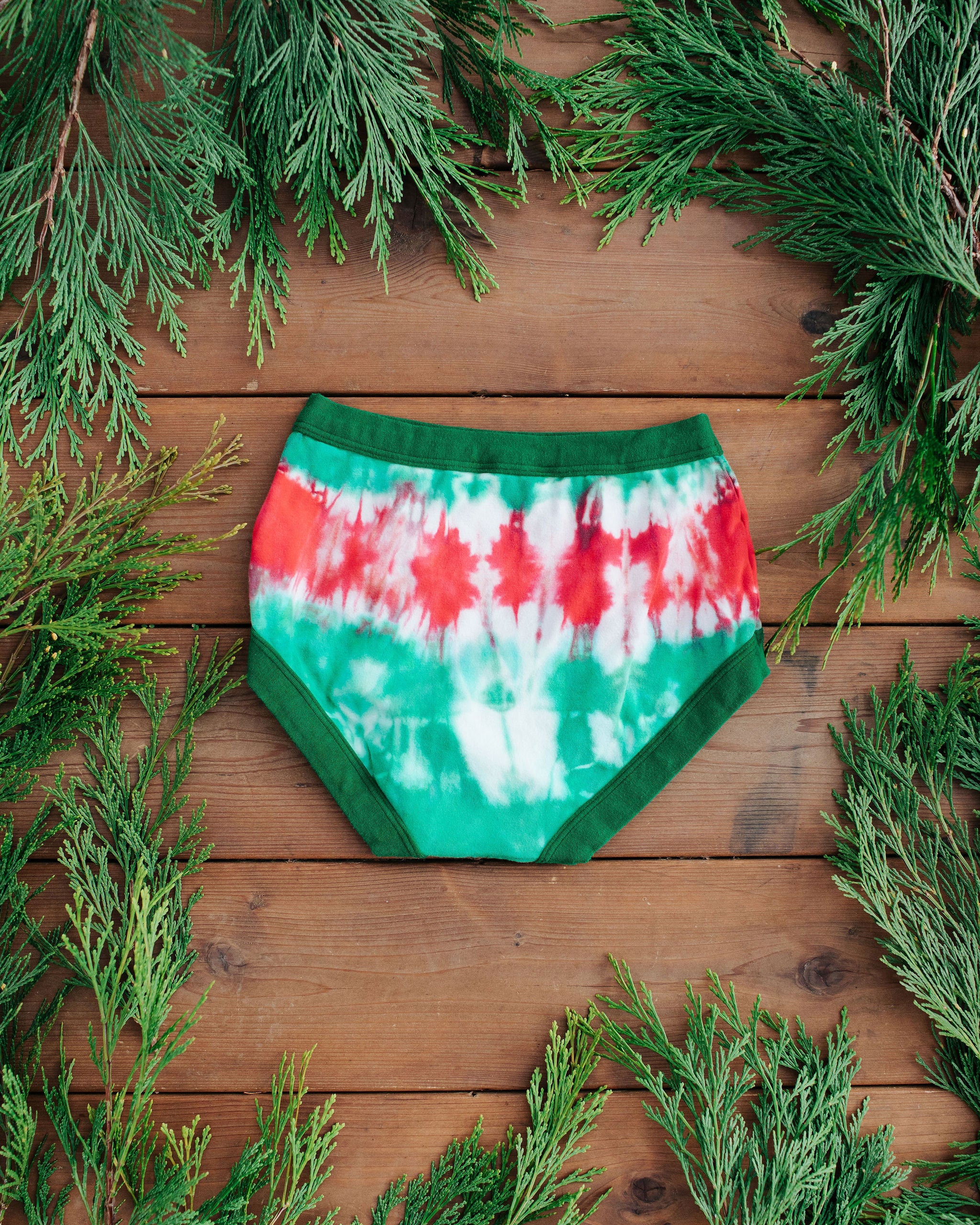 Flat lay of Thunderpants Original style underwear in Holiday Dye - red and green tie dye with green binding. 