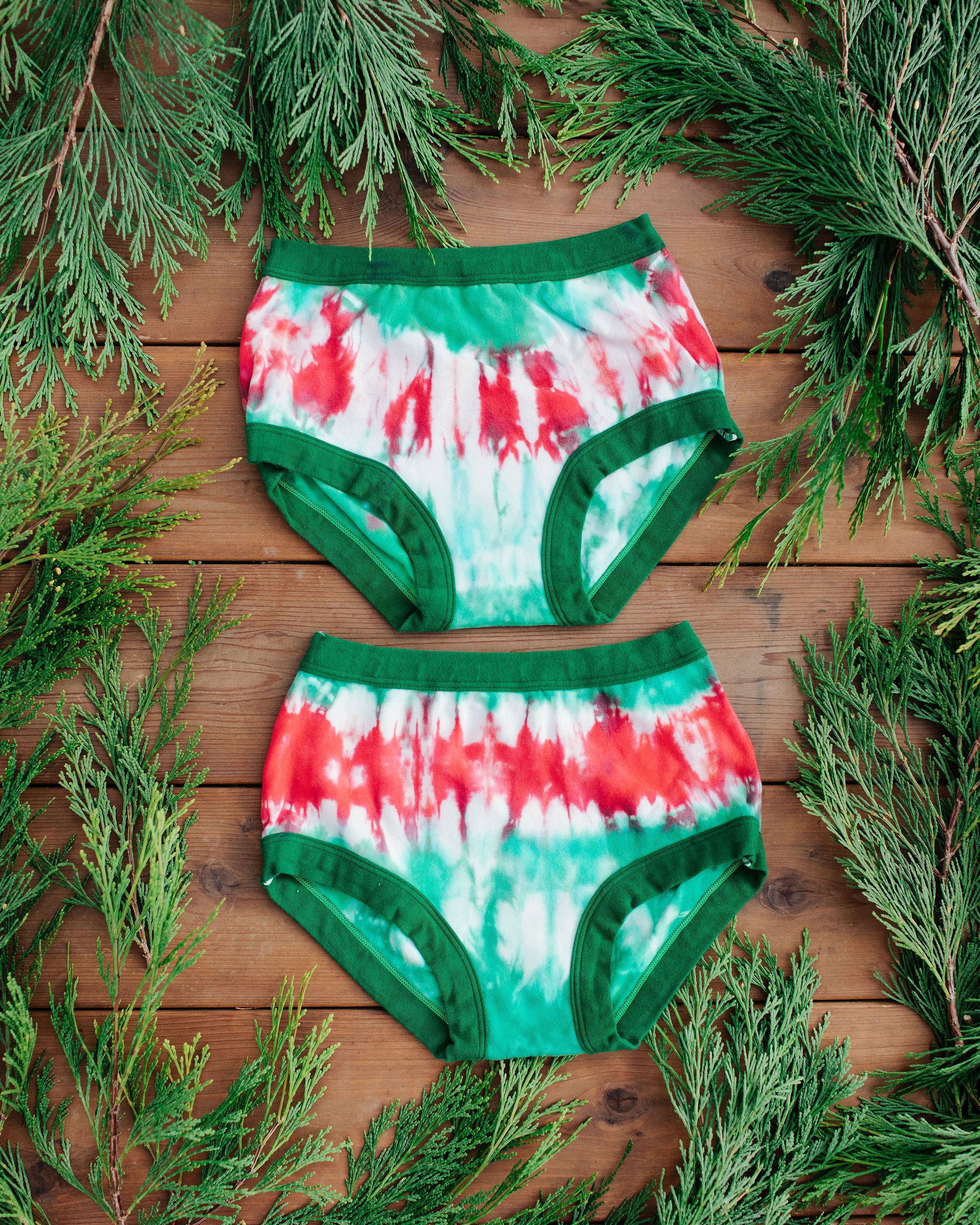 Flat lay of two Thunderpants Original style underwear in Holiday Dye - red and green tie dye with green binding. 