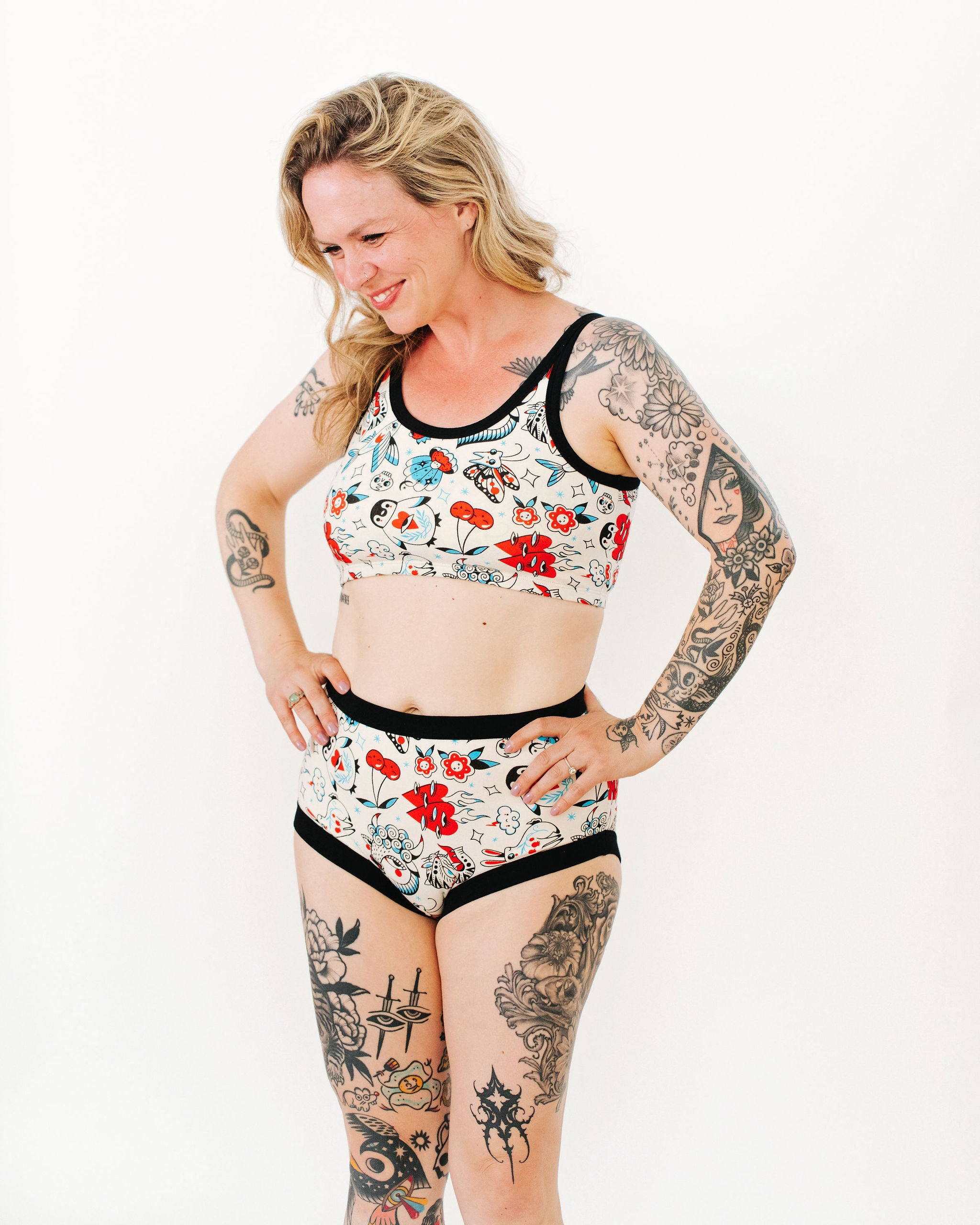 Model wearing Thunderpants Original style underwear and Longline Bra in Inked Up - a tattoo pattern with black, red, and blue. 