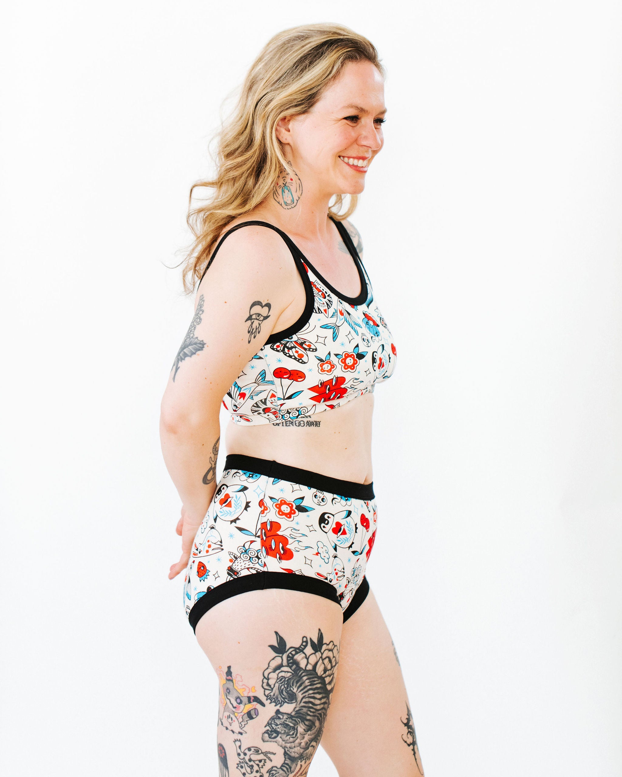 Model wearing Thunderpants Original style underwear and Longline Bra in Inked Up - a tattoo pattern with black, red, and blue. 