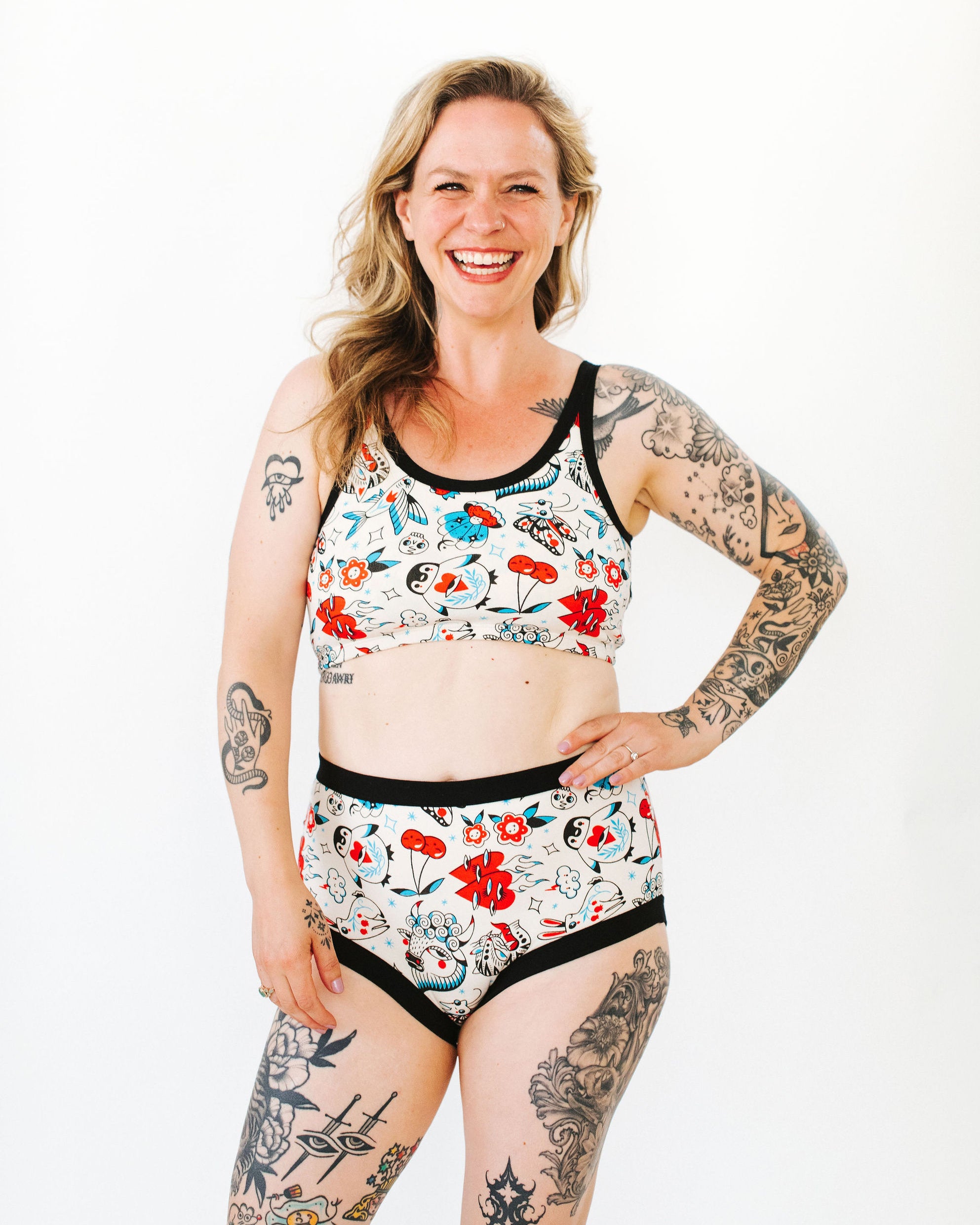 Model wearing Thunderpants Original style underwear and Longline Bra in Inked Up - a tattoo pattern with black, red, and blue. 