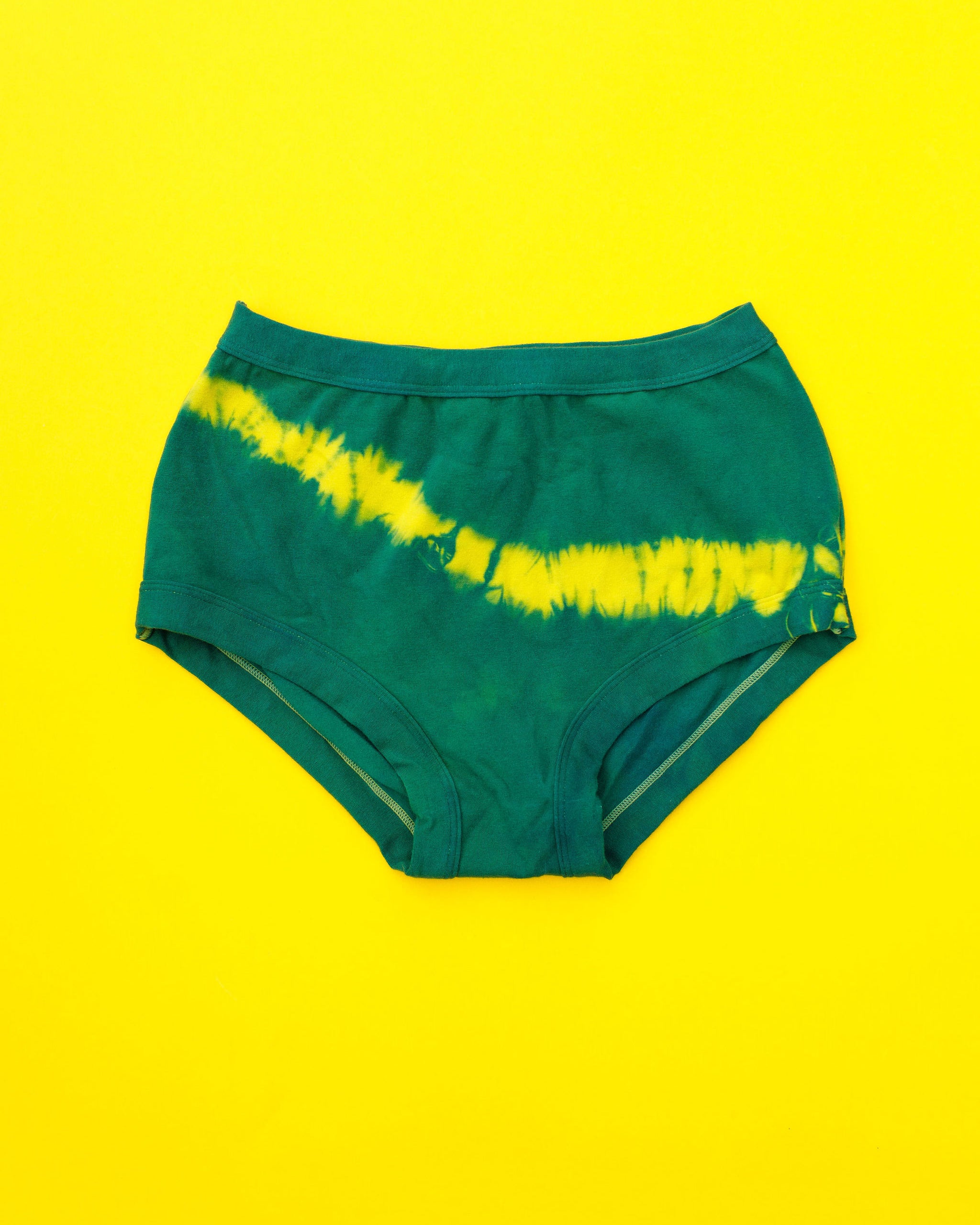 Flat lay of Thunderpants Original style underwear in Lightning Bolt hand dye - blue/green with yellow stripe.