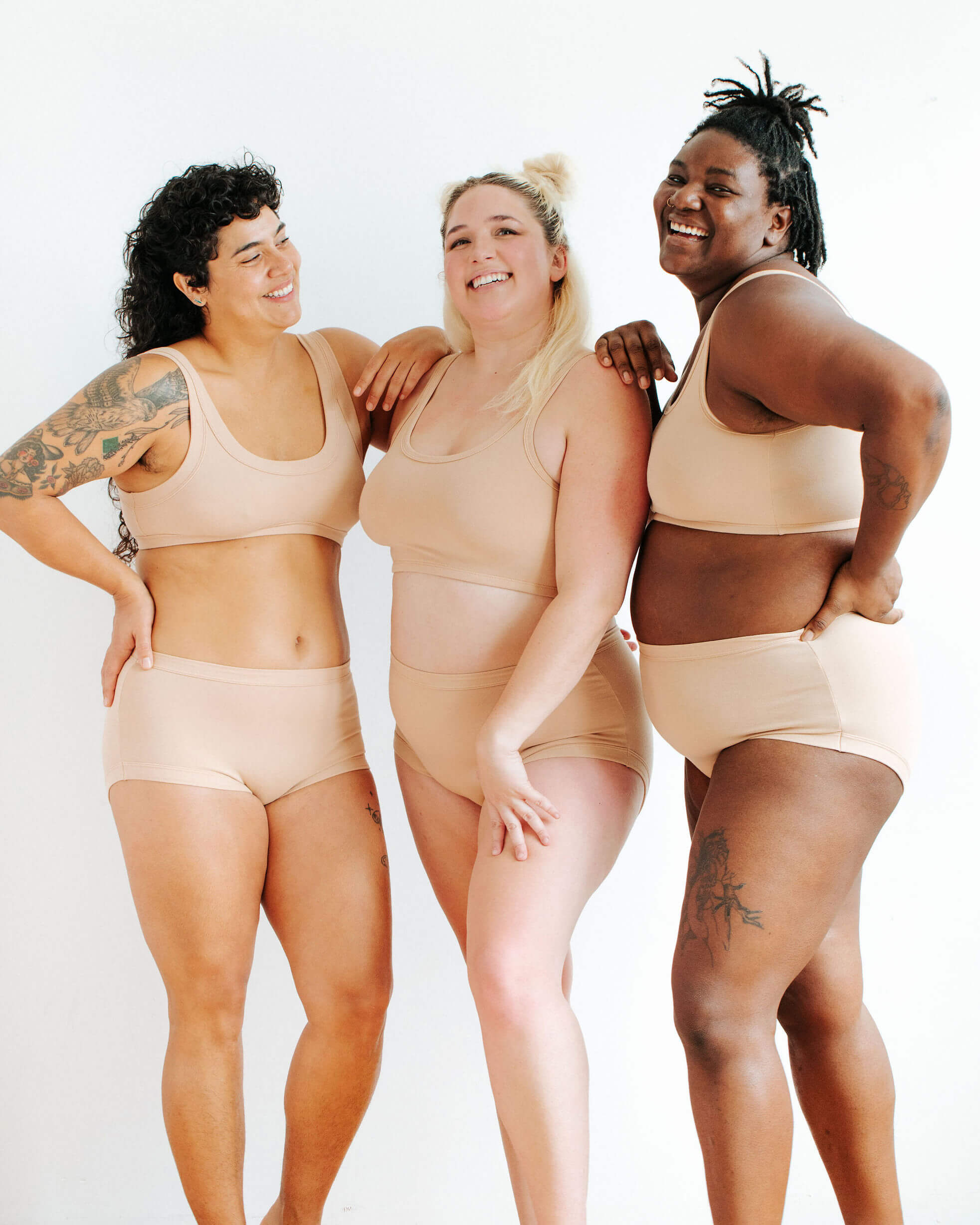 Three models wearing Thunderpants Original style underwear and Bras in Pine Nut - lighter tan color.