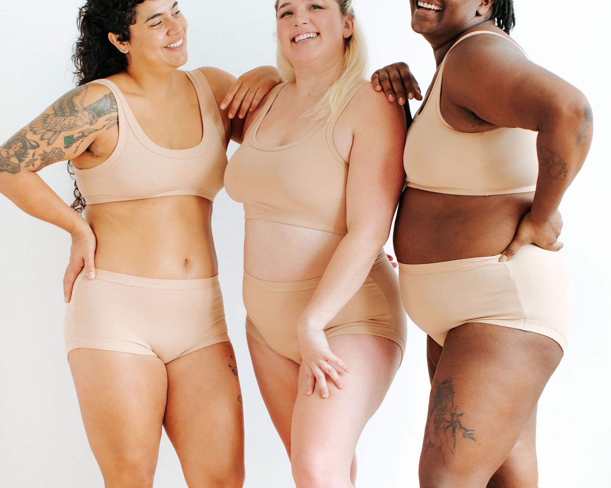 Three models wearing Thunderpants Original style underwear and Bras in Pine Nut - lighter tan color.