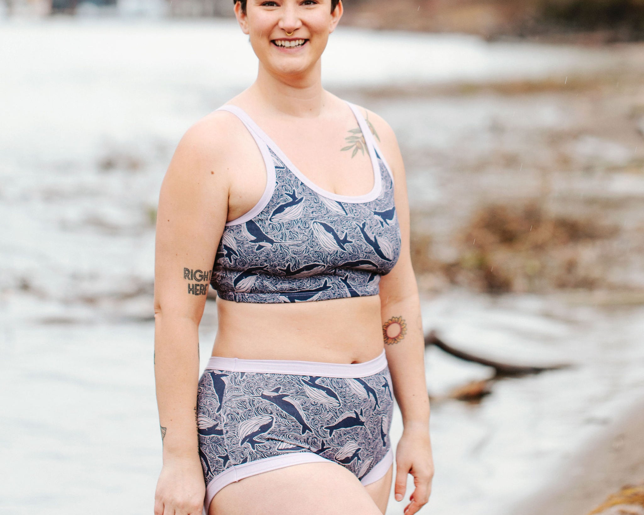 Model wearing Thunderpants Original style underwear and Longline Bra in Whale, Whale, Whale print - indigo whales on lavender.