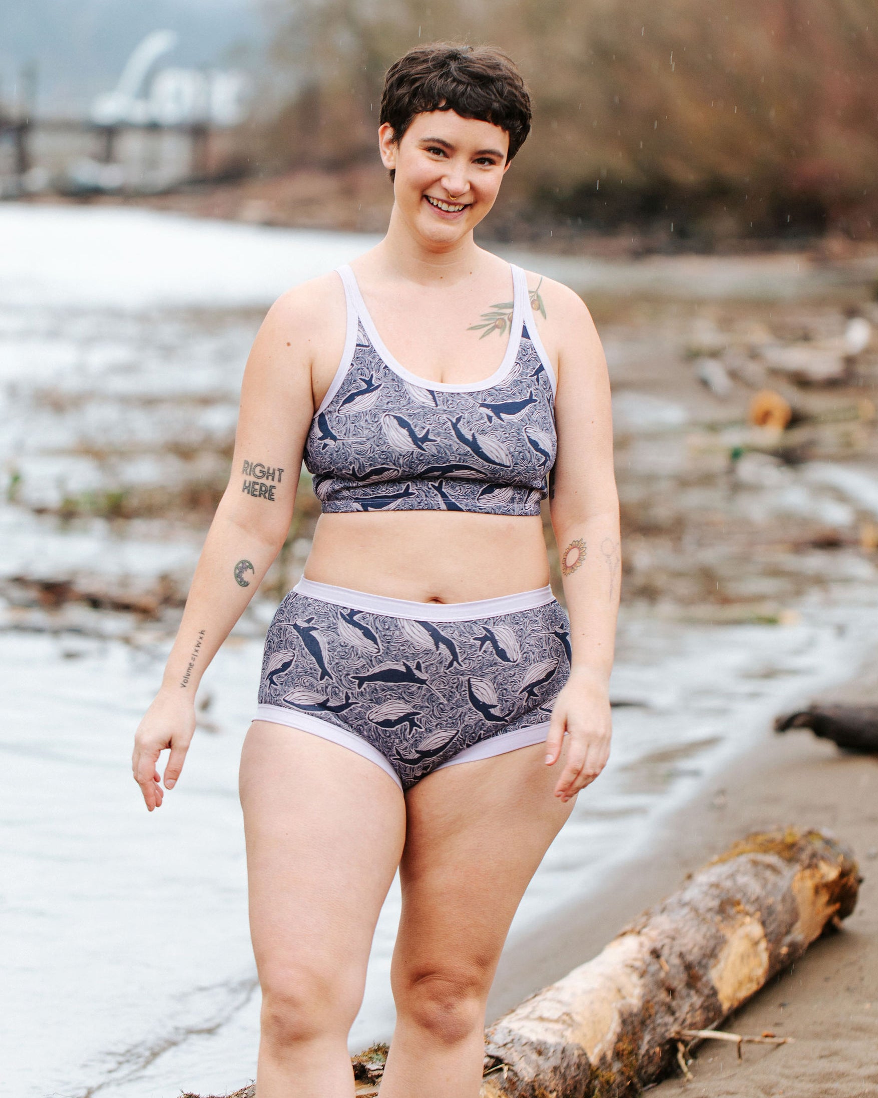 Model wearing Thunderpants Original style underwear and Longline Bra in Whale, Whale, Whale print - indigo whales on lavender.