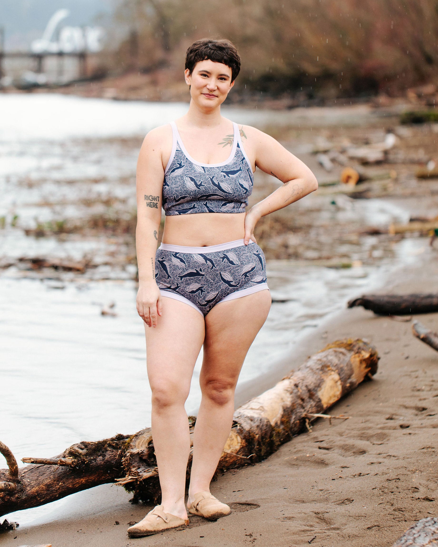 Model wearing Thunderpants Original style underwear and Longline Bra in Whale, Whale, Whale print - indigo whales on lavender.