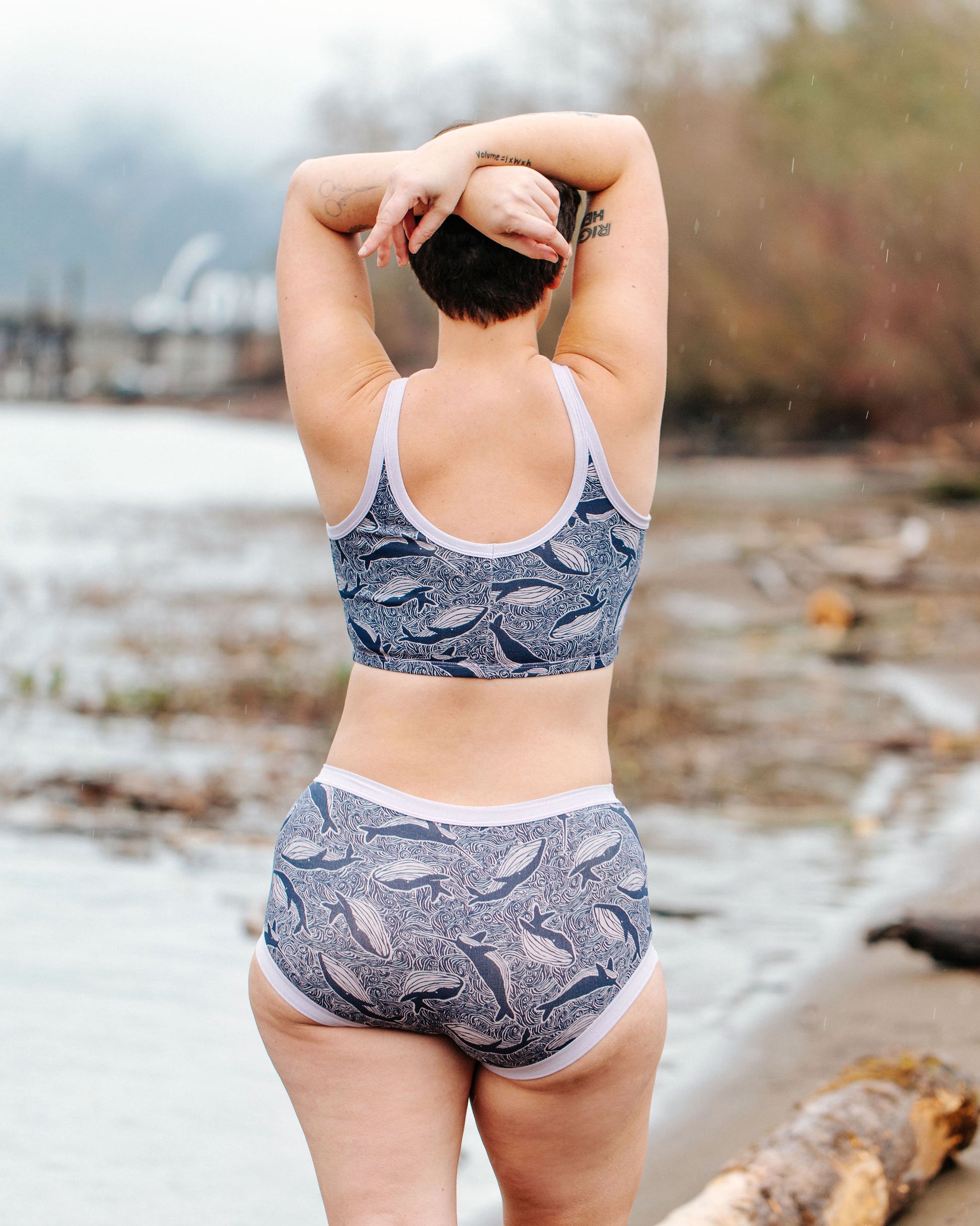 Model wearing Thunderpants Original style underwear and Longline Bra in Whale, Whale, Whale print - indigo whales on lavender.
