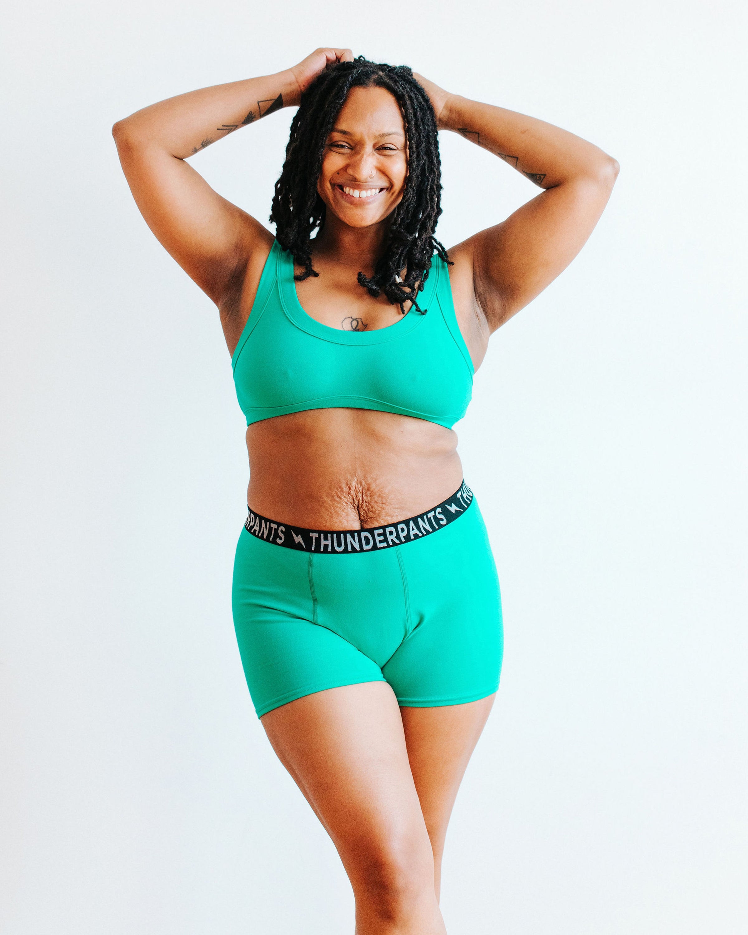 Model wearing Thunderpants Boxer Brief style underwear and Bralette in Peacock Green.