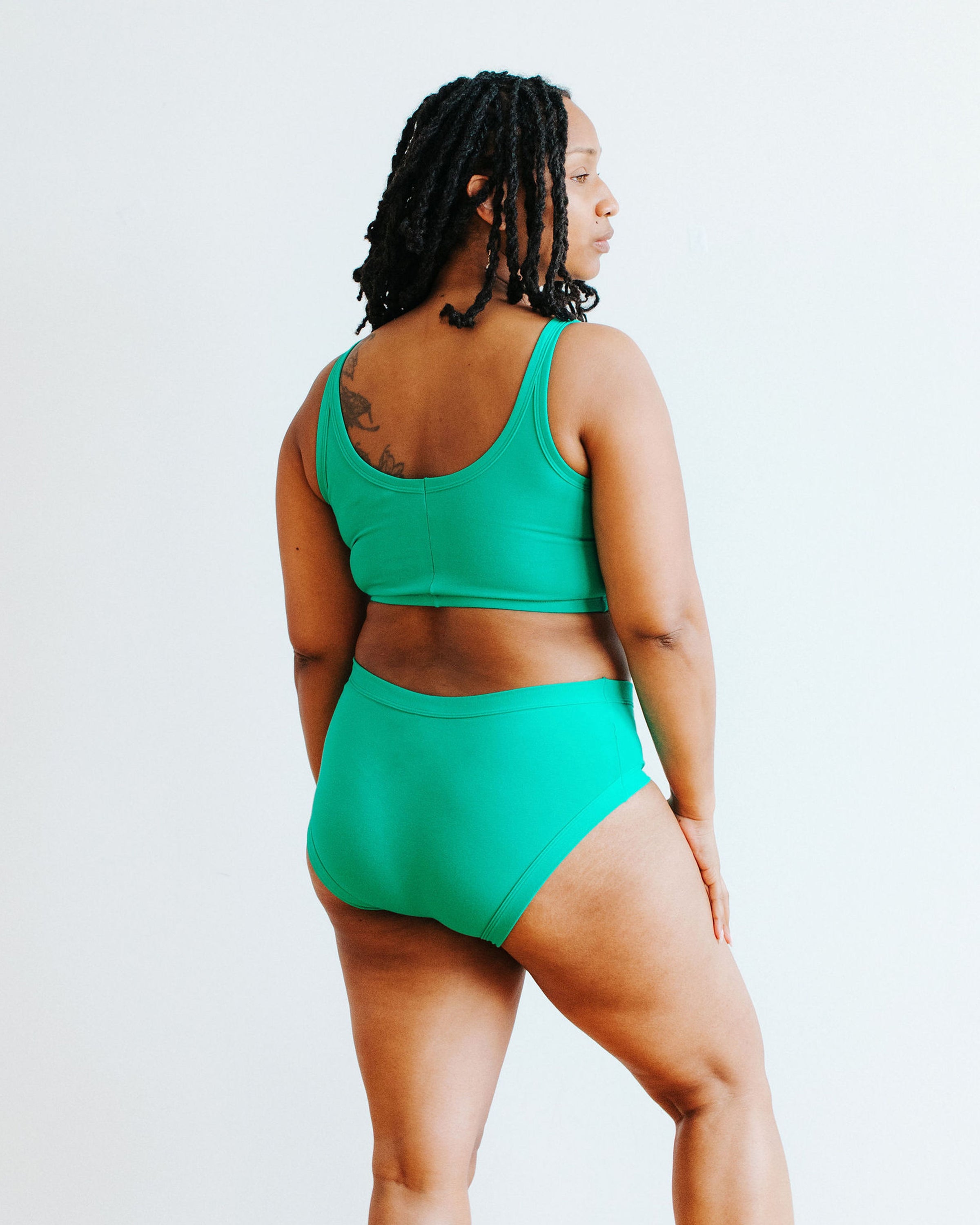 Model wearing Thunderpants Hipster style underwear and Longline Bra in Peacock Green.