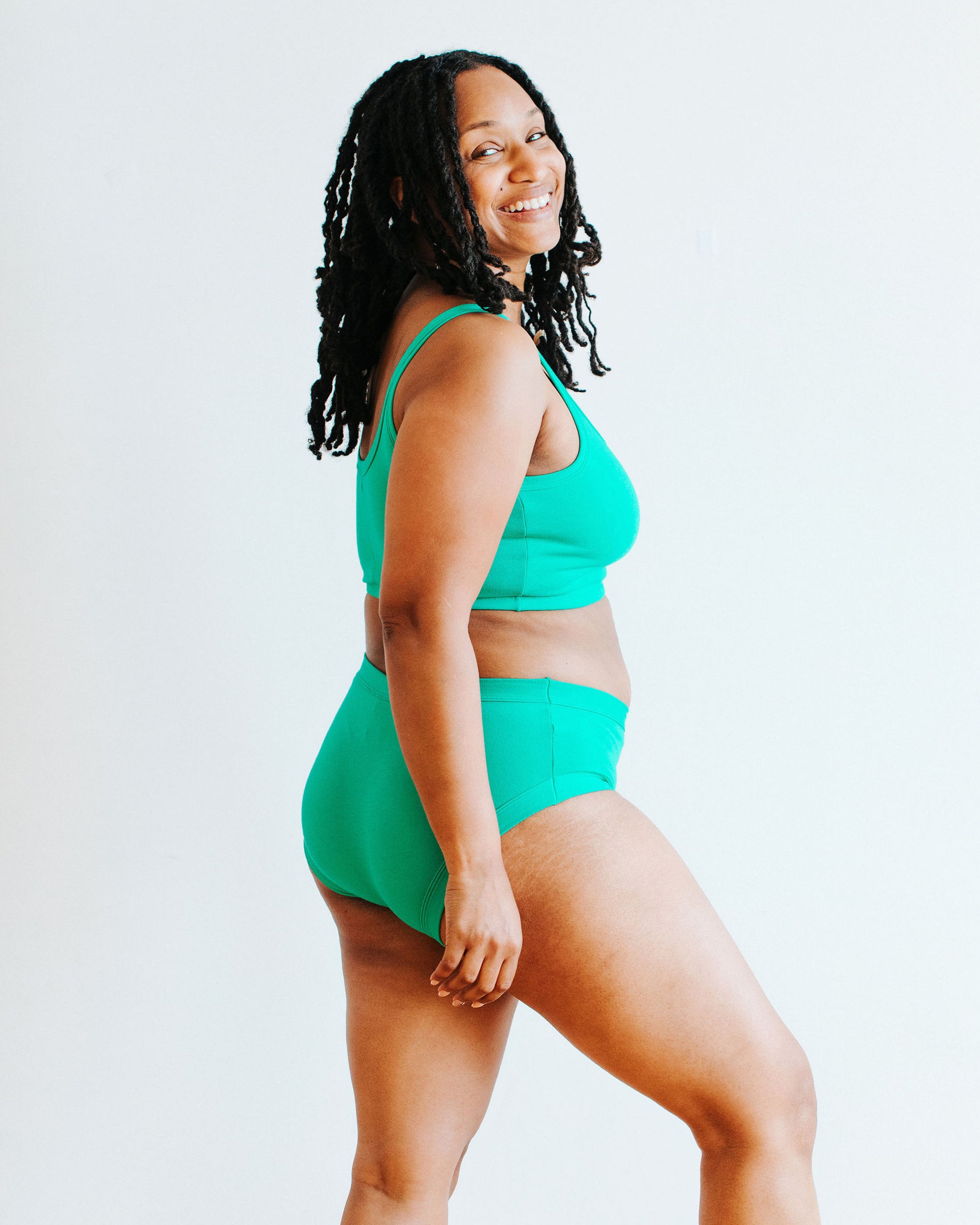Model wearing Thunderpants Hipster style underwear and Longline Bra in Peacock Green.