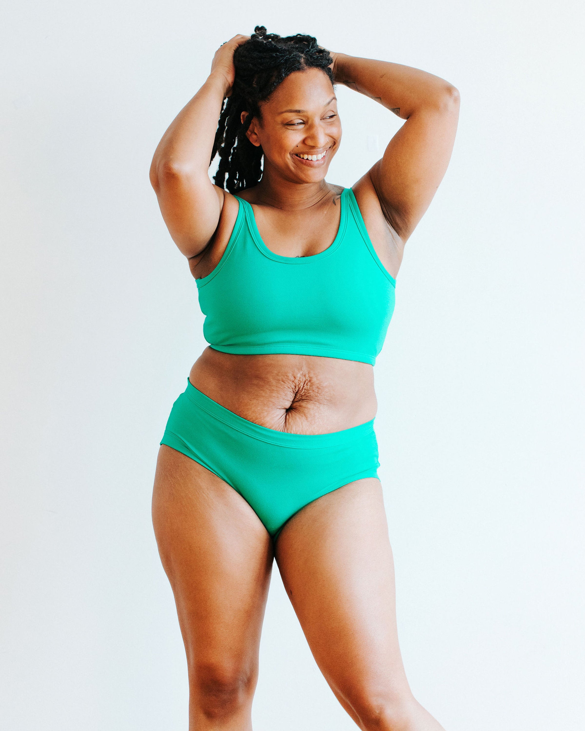 Model wearing Thunderpants Hipster style underwear and Longline Bra in Peacock Green.