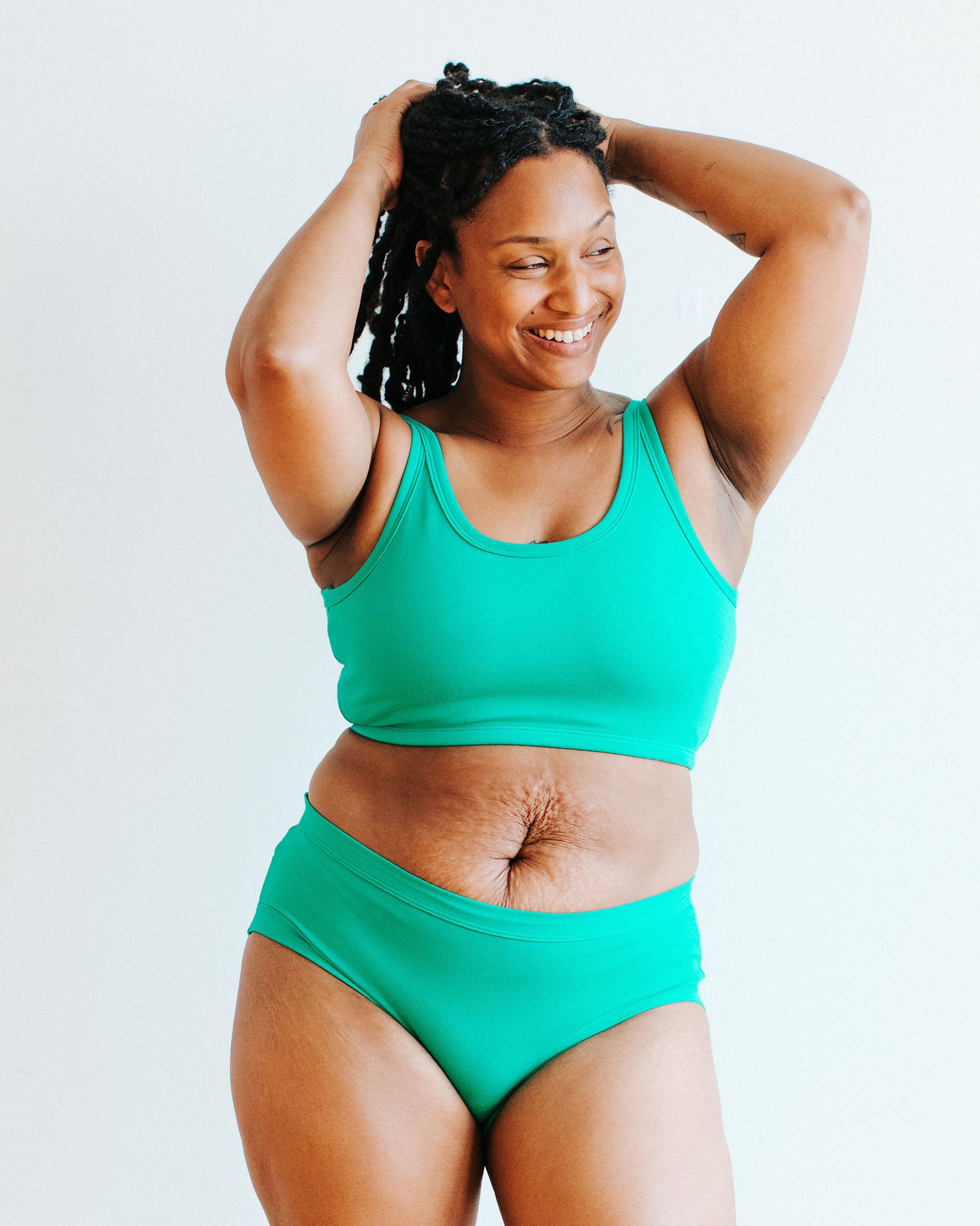Model wearing Thunderpants Longline Bra and Hipster style underwear in Peacock Green.