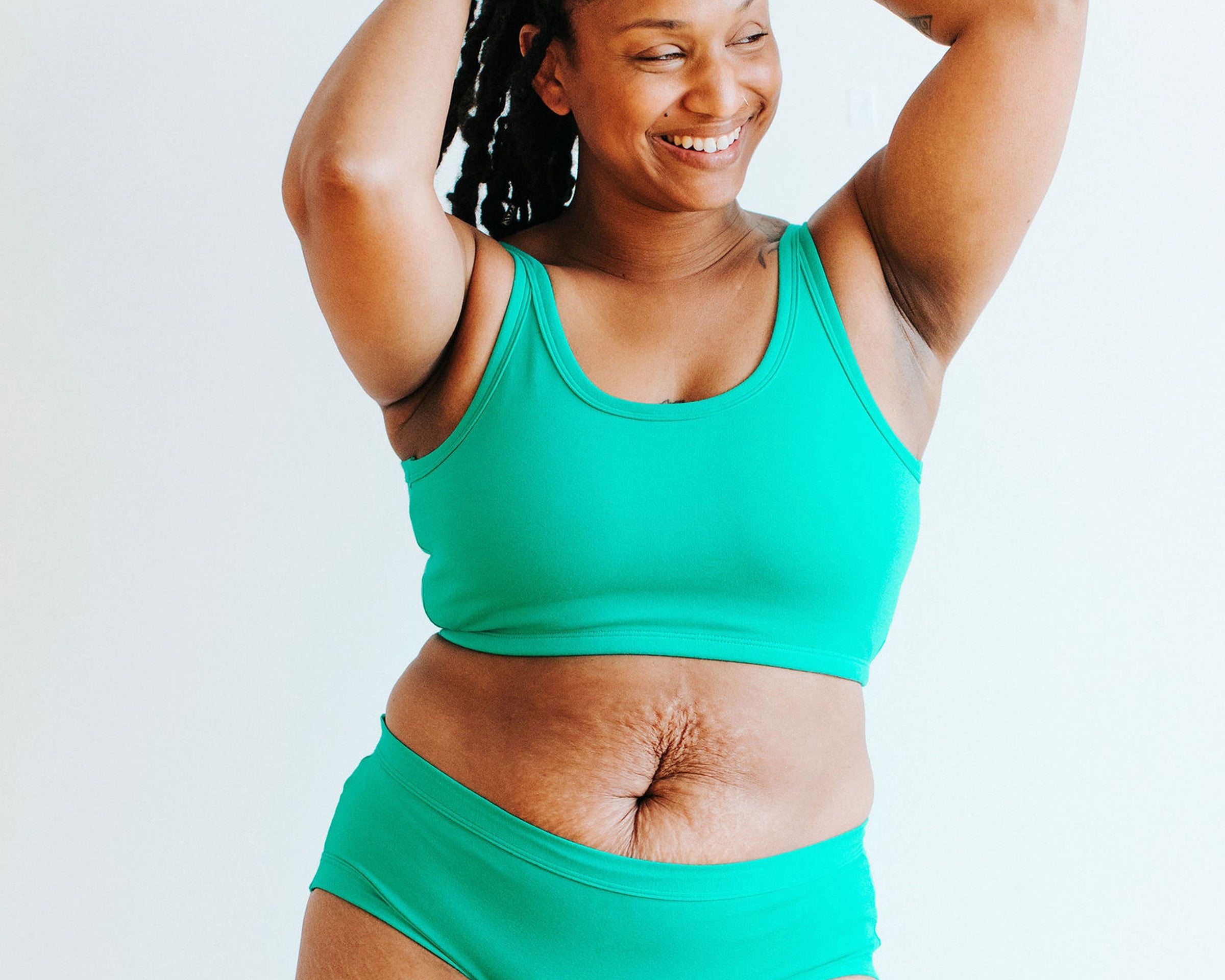 Model wearing Thunderpants Longline Bra and Hipster style underwear in Peacock Green.