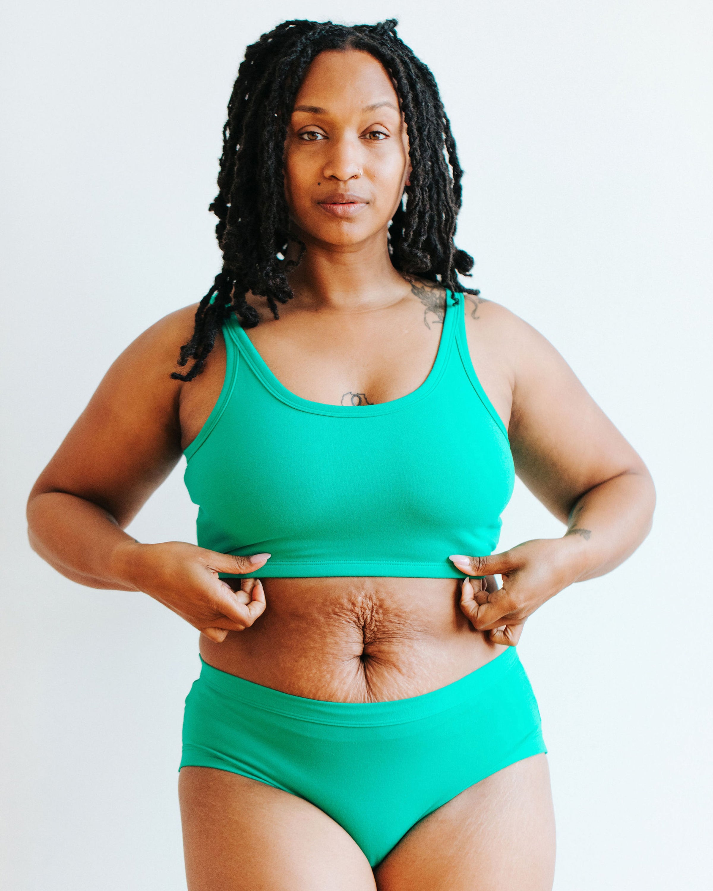 Model wearing Thunderpants Longline Bra and Hipster style underwear in Peacock Green.