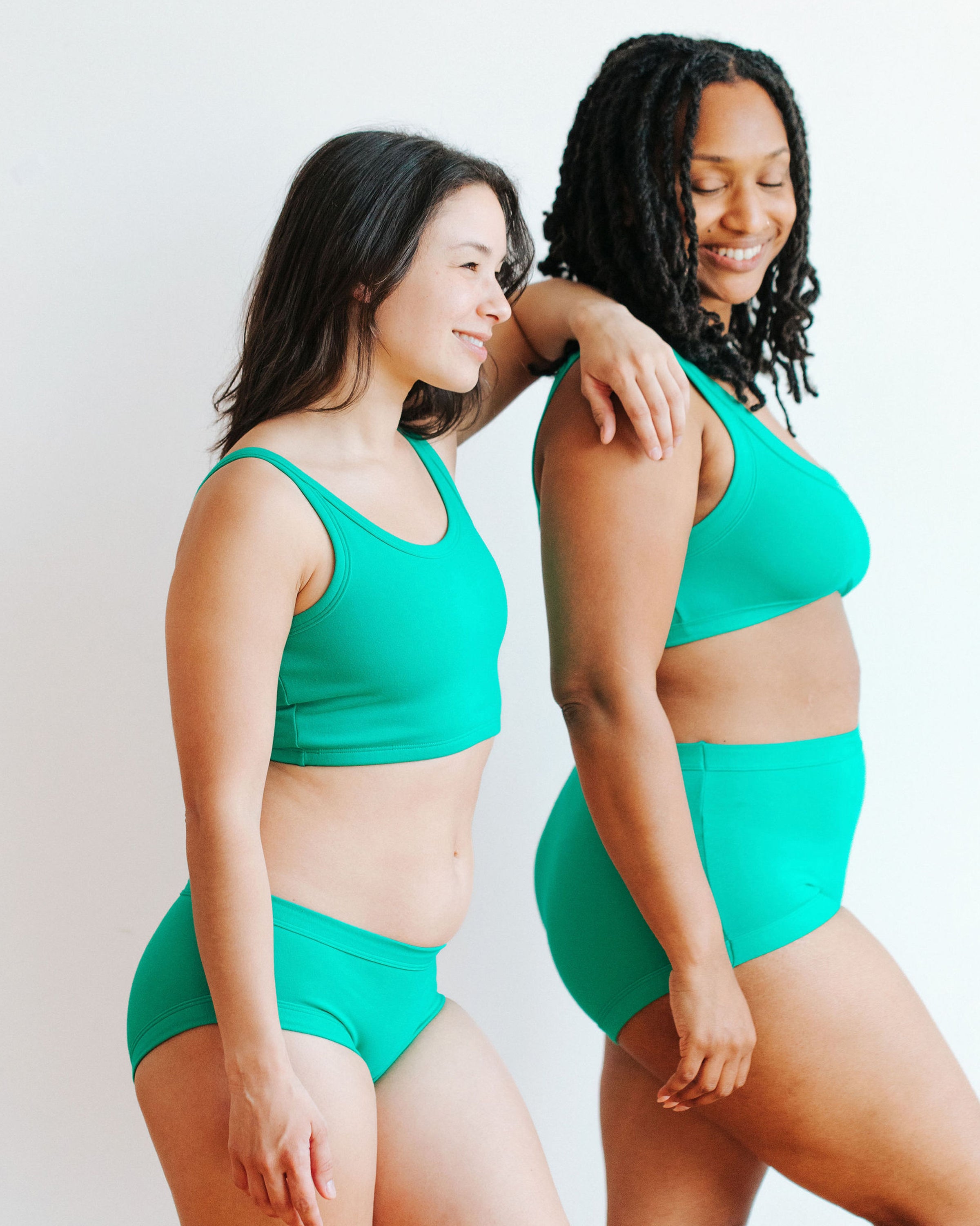 Two models wearing various styles of Thunderpants in Peacock Green.