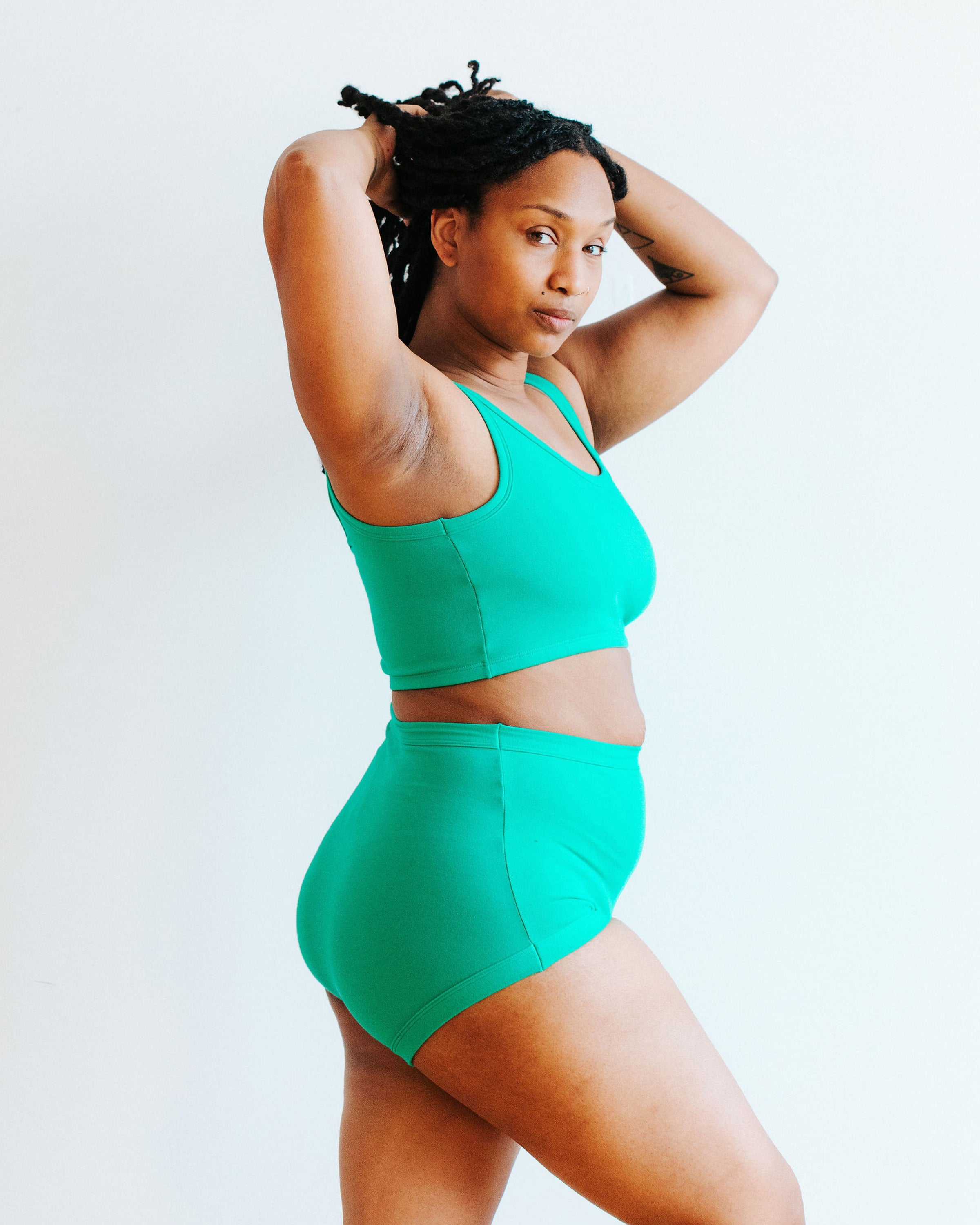Model wearing Thunderpants Sky Rise style underwear and Longline Bra in Peacock Green.