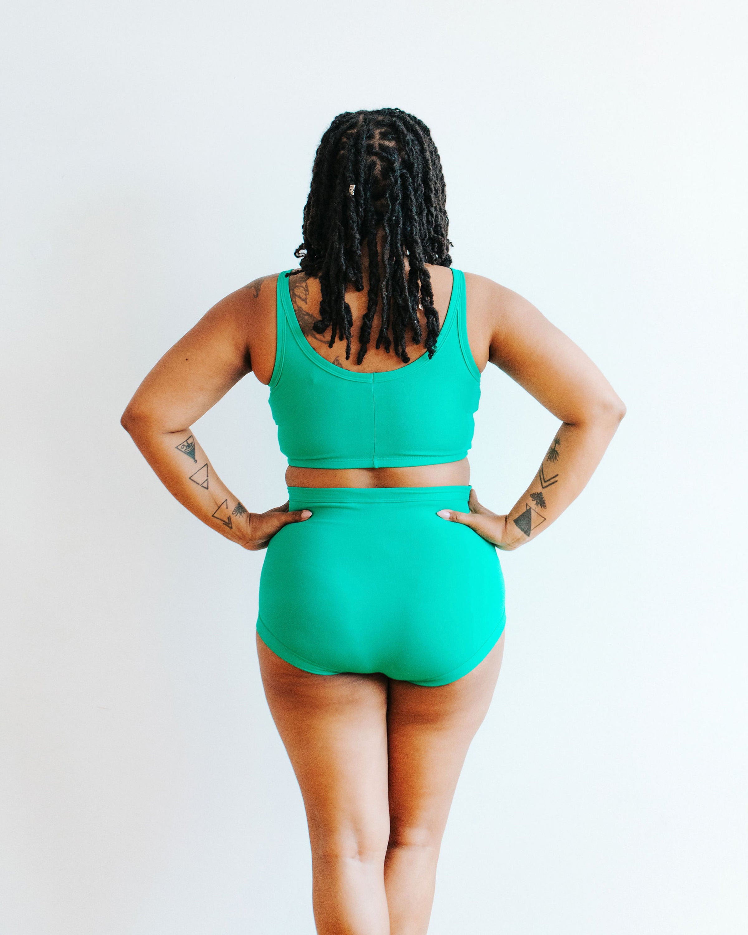 Model wearing Thunderpants Sky Rise style underwear and Longline Bra in Peacock Green.