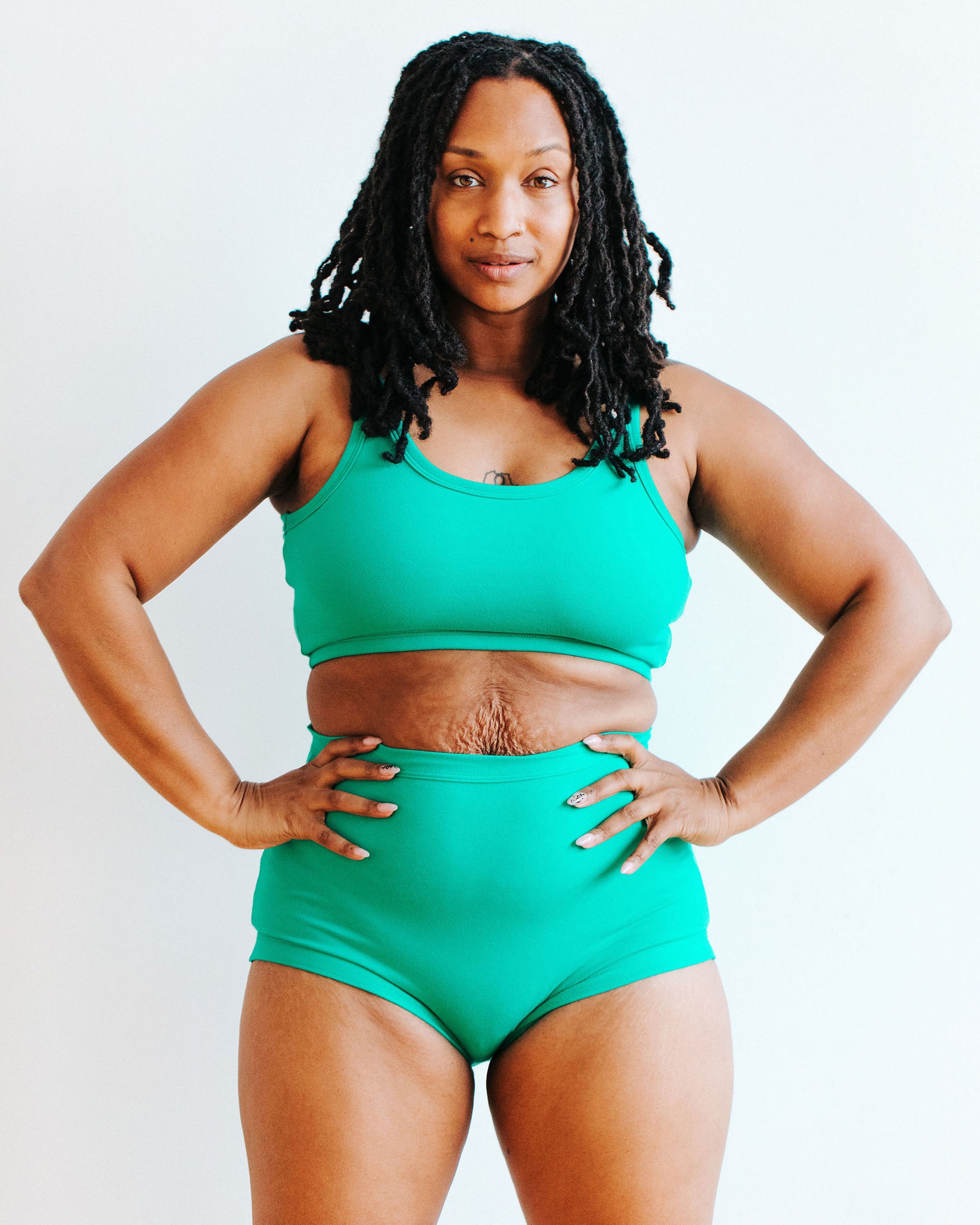 Model wearing Thunderpants Sky Rise style underwear and Longline Bra in Peacock Green.