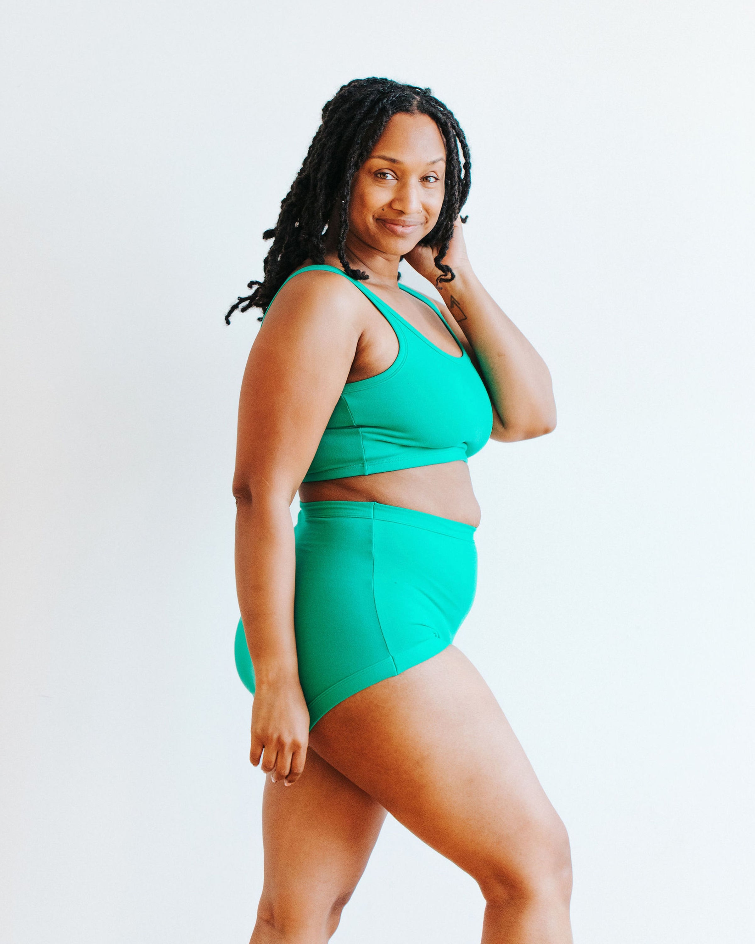 Model wearing Thunderpants Sky Rise style underwear and Longline Bra in Peacock Green.