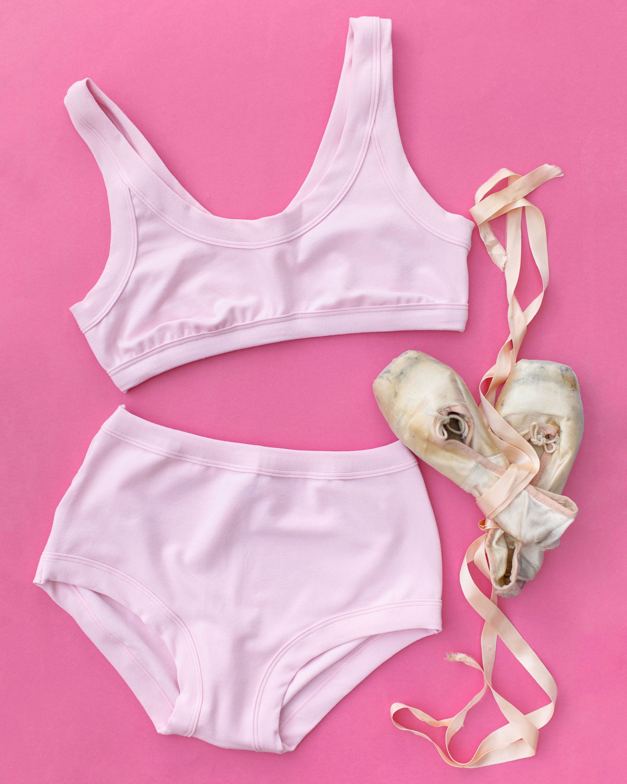 Flat lay of Thunderpants Bralette  and Original style underwear in Plié Pink - light pink color.