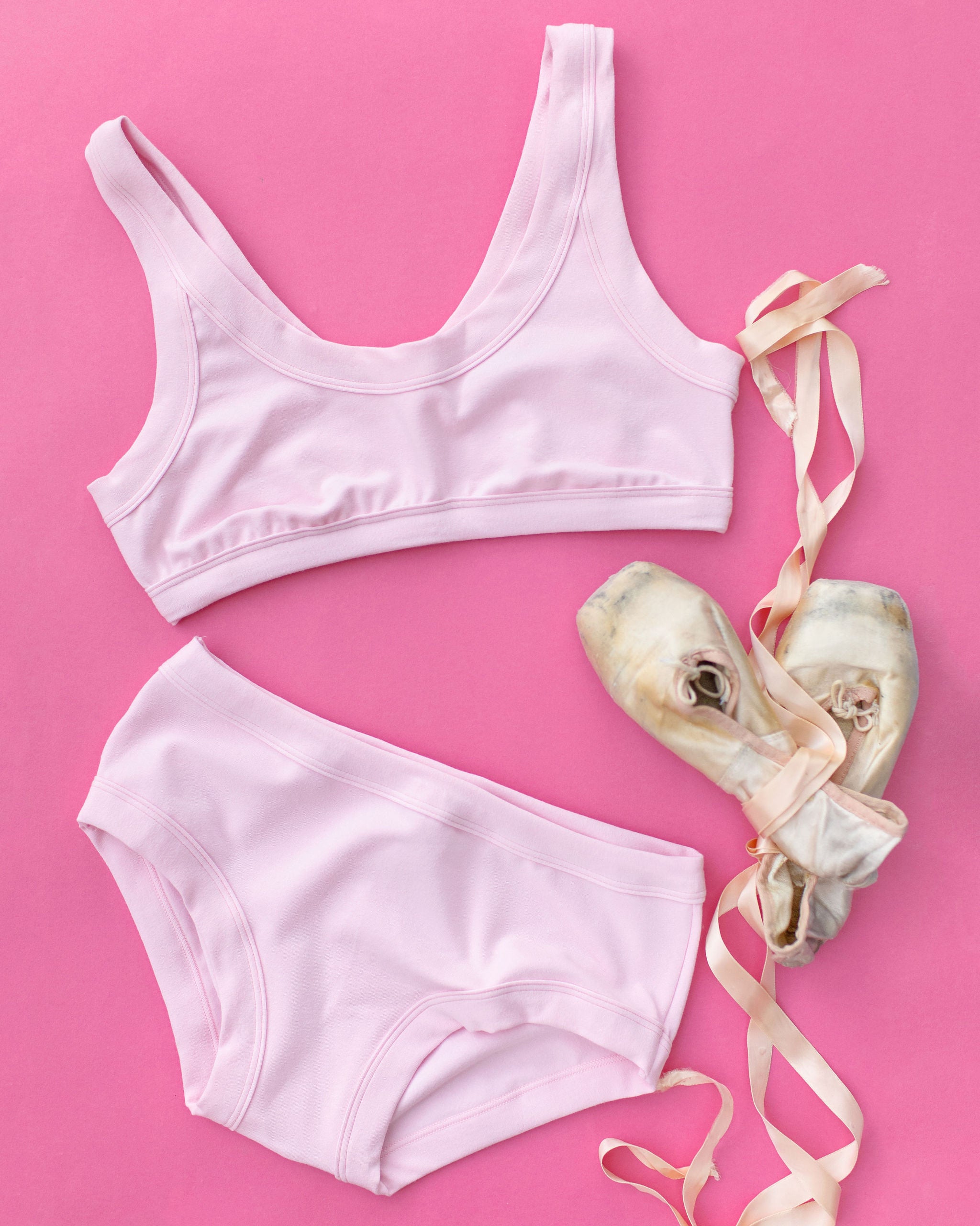 Flat lay of Thunderpants Hipster style underwear and Bralette in Plié Pink - light pink color.
