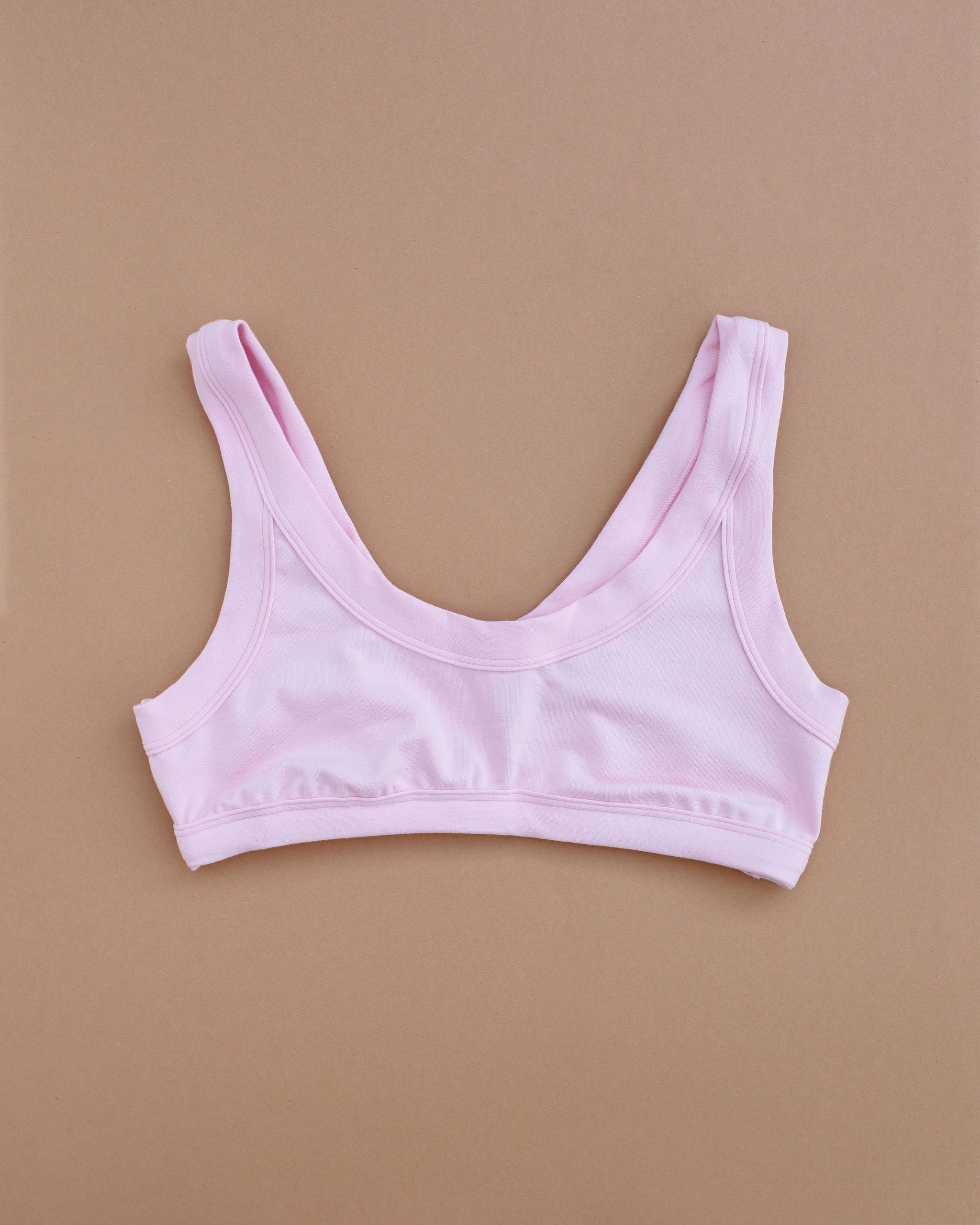 Flat lay of Thunderpants Bralette in Plié Pink - light pink color.
