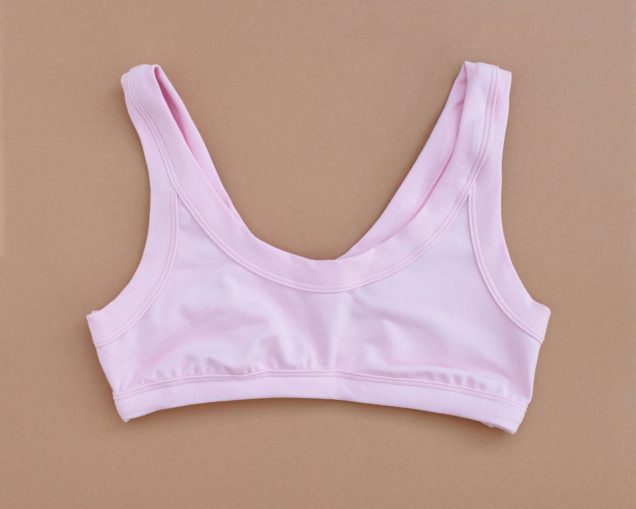 Flat lay of Thunderpants Bralette in Plié Pink - light pink color.
