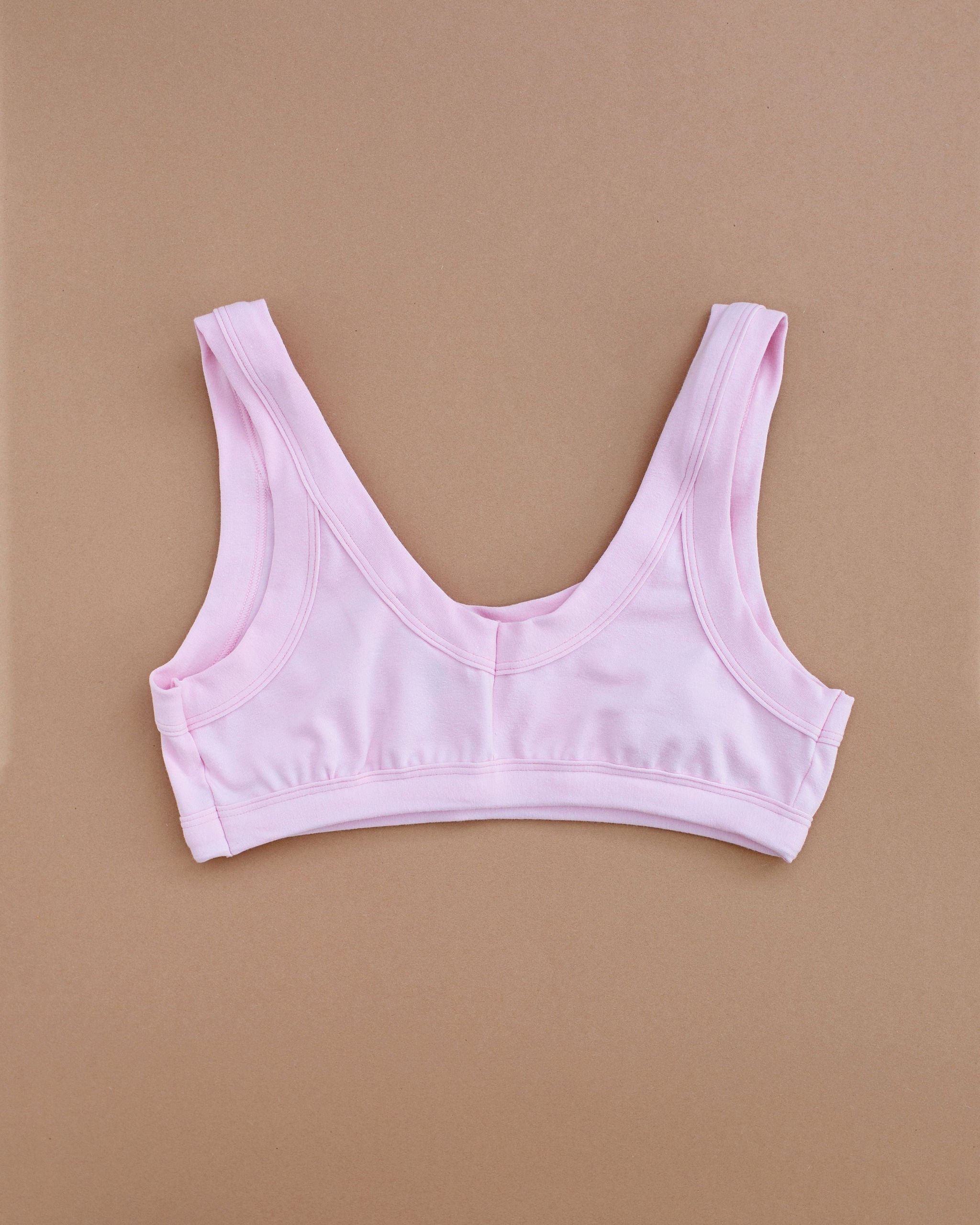 Flat lay of Thunderpants Bralette in Plié Pink - light pink color.