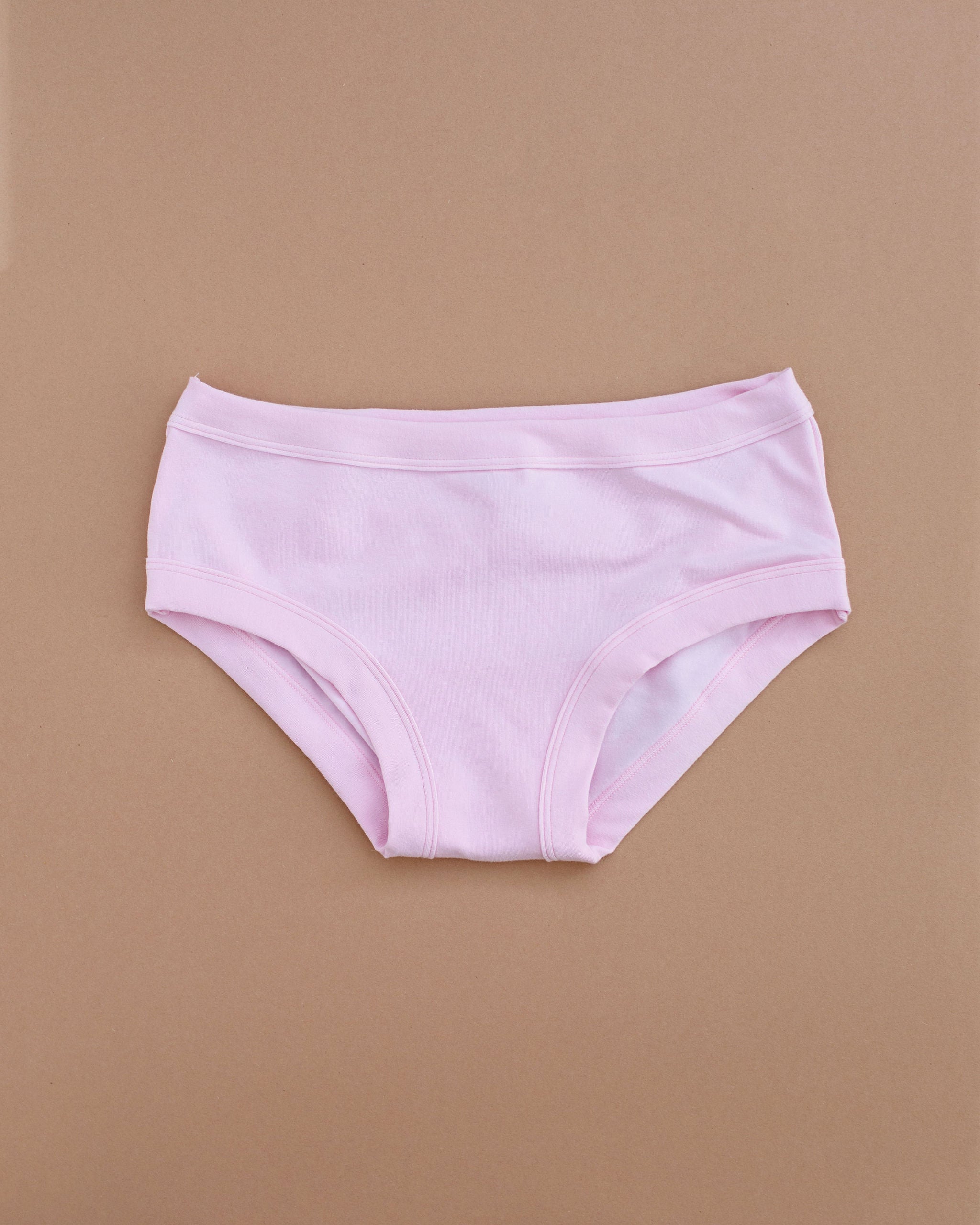 Flat lay of Thunderpants Hipster style underwear in Plié Pink - light pink color.