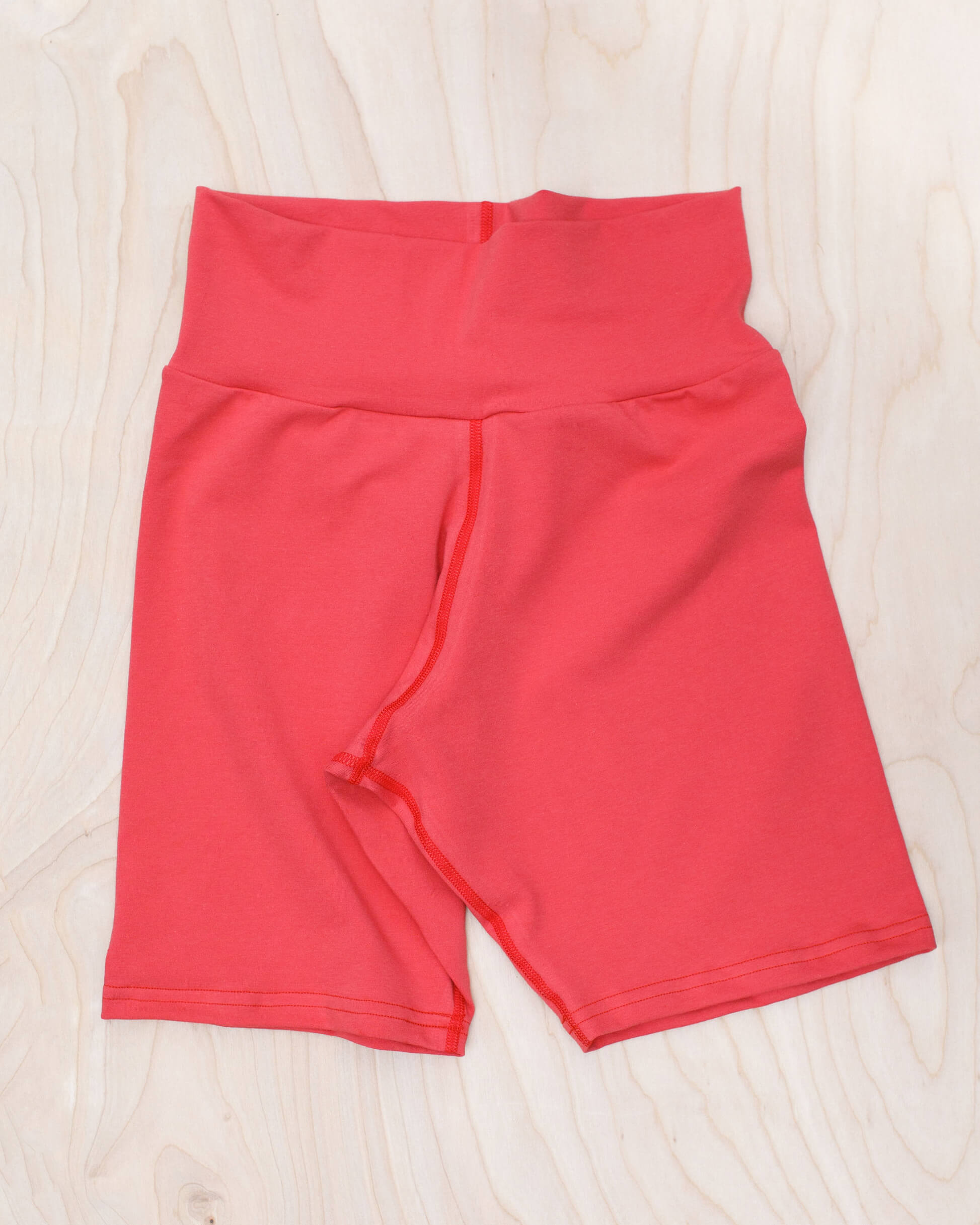 Flat lay of Thunderpants Bike Shorts in Pomegranate Punch color.