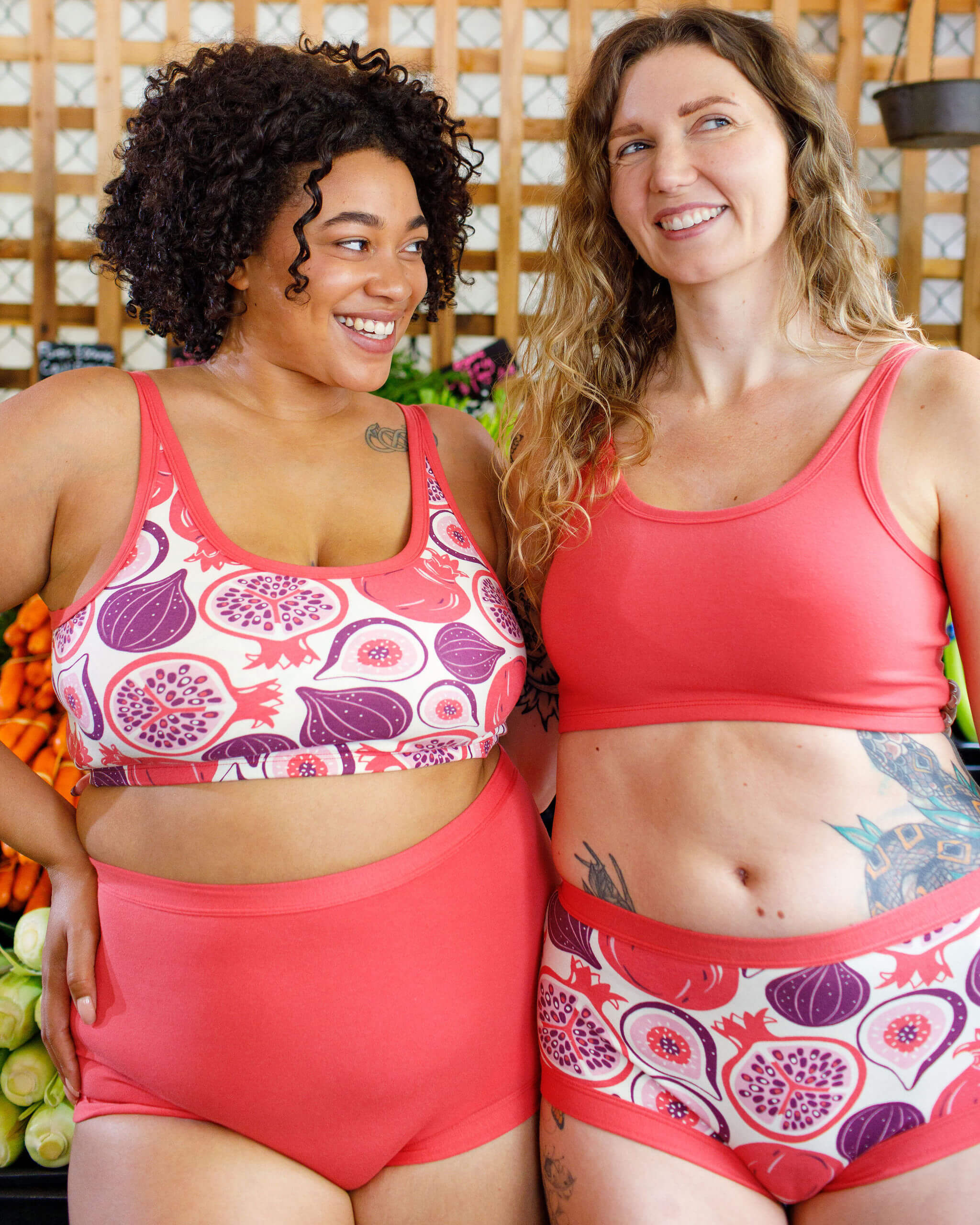 Two models wearing various Thunderpants items in Pomegranate Punch and Two Fruits.