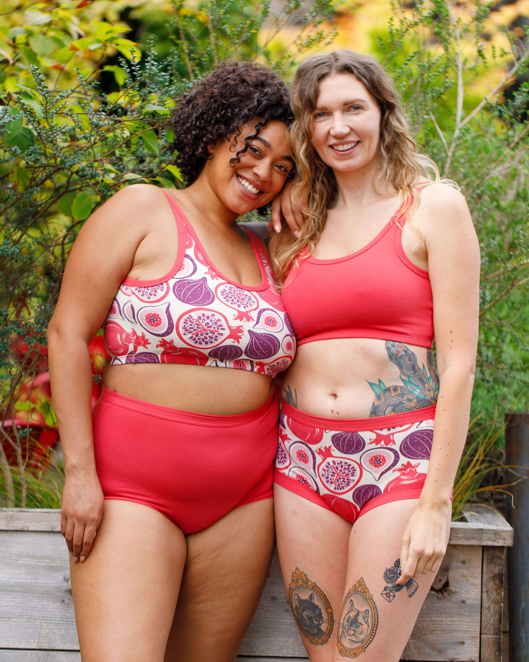 Two models wearing various Thunderpants items in Pomegranate Punch and Two Fruits.