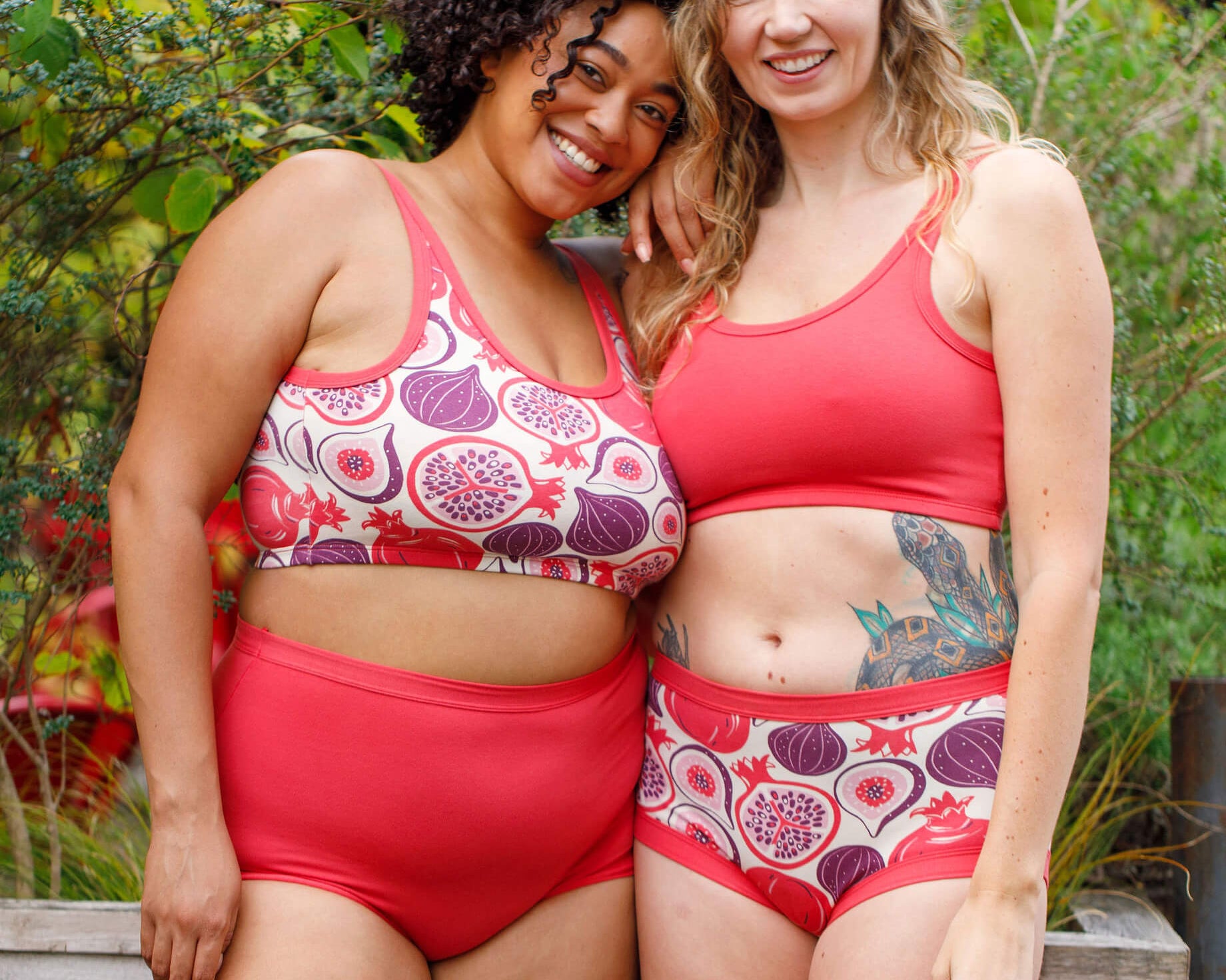 Two models wearing various Thunderpants items in Pomegranate Punch and Two Fruits.