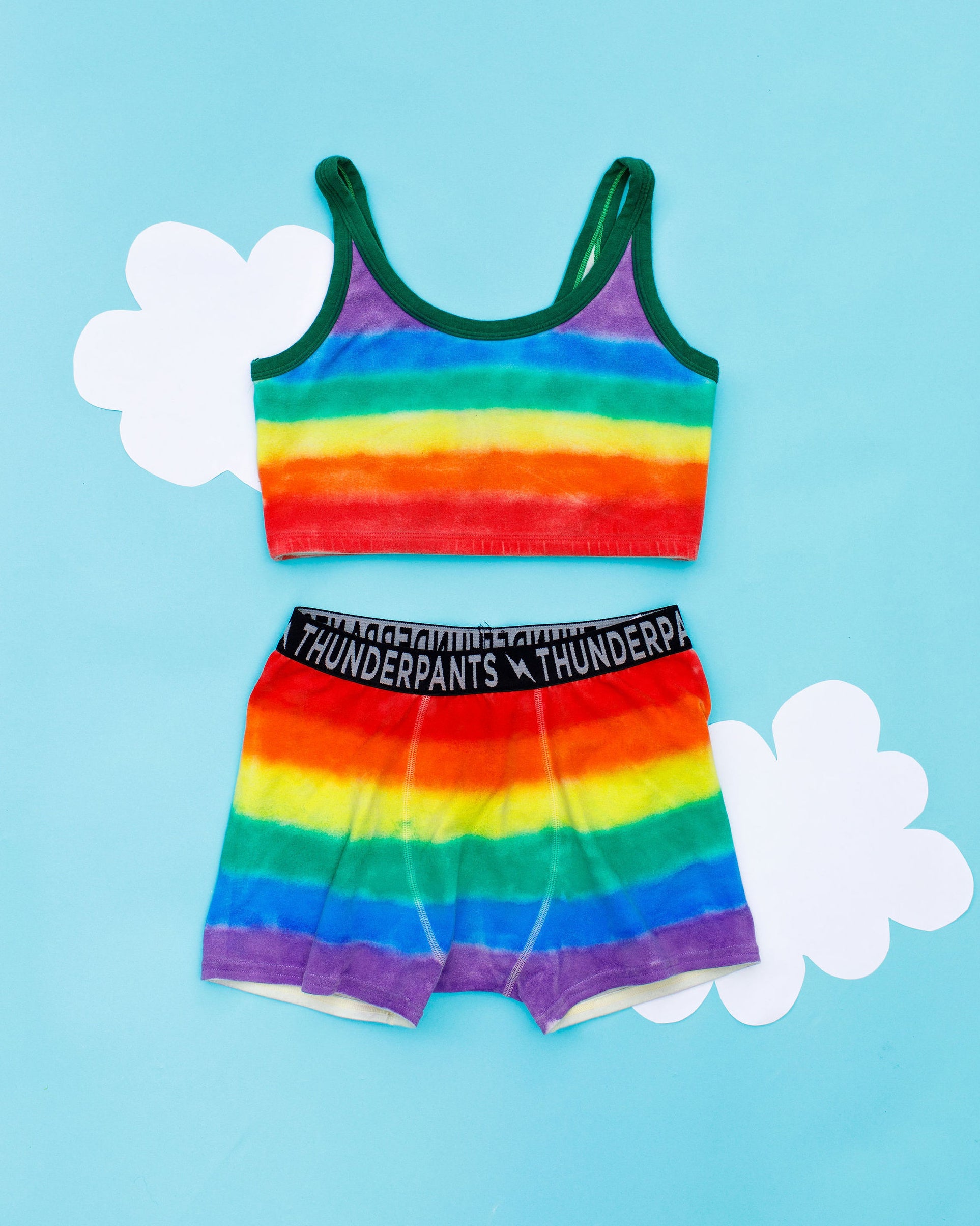Flat lay of Thunderpants Boxer Brief style underwear and Longline Bra in rainbow dye with emerald green binding.