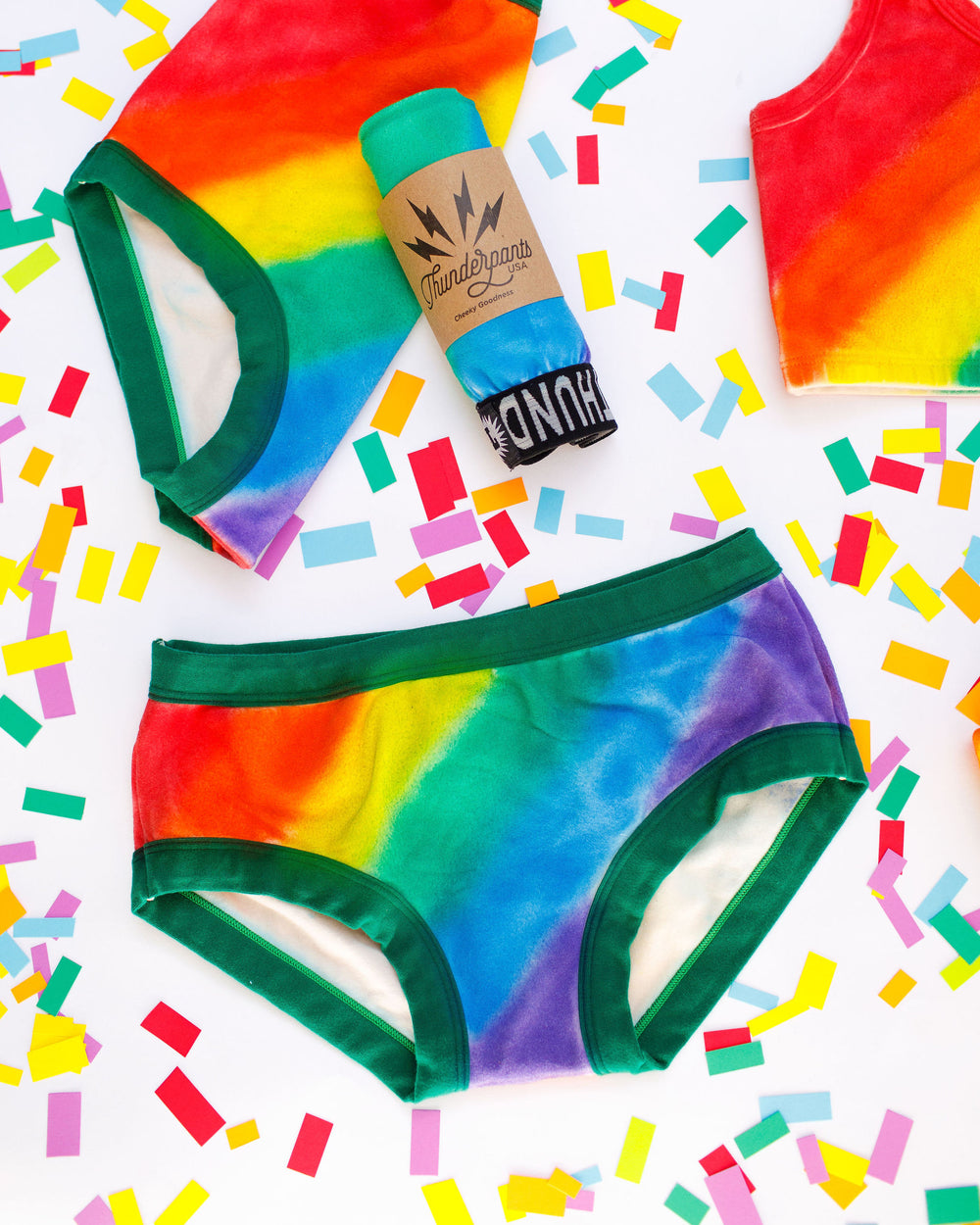 Thunderpants organic cotton Hipster style underwear in hand painted rainbow stripes for Pride laying on rainbow confetti.