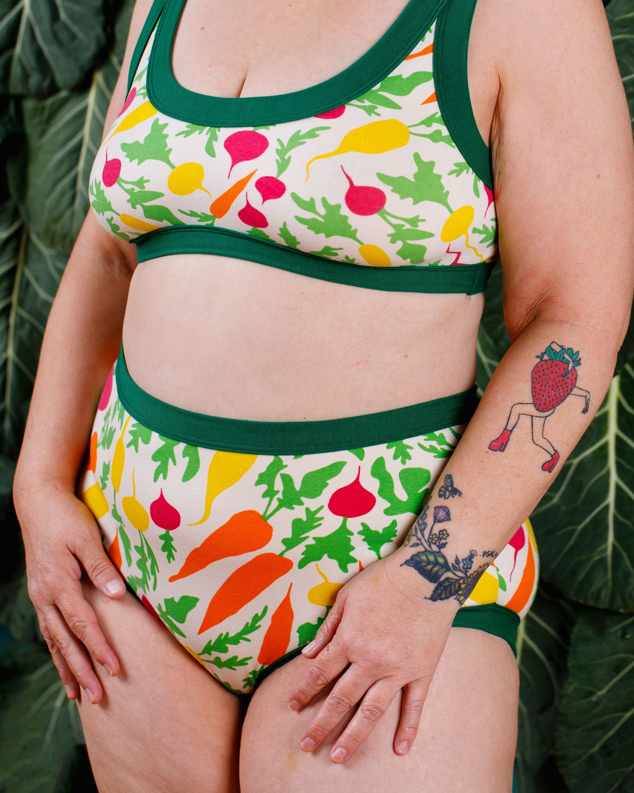 Close up of model wearing Thunderants Original style underwear and matching Bralette in Root Veggies print - yellow, orange, pink, and green vegetables.