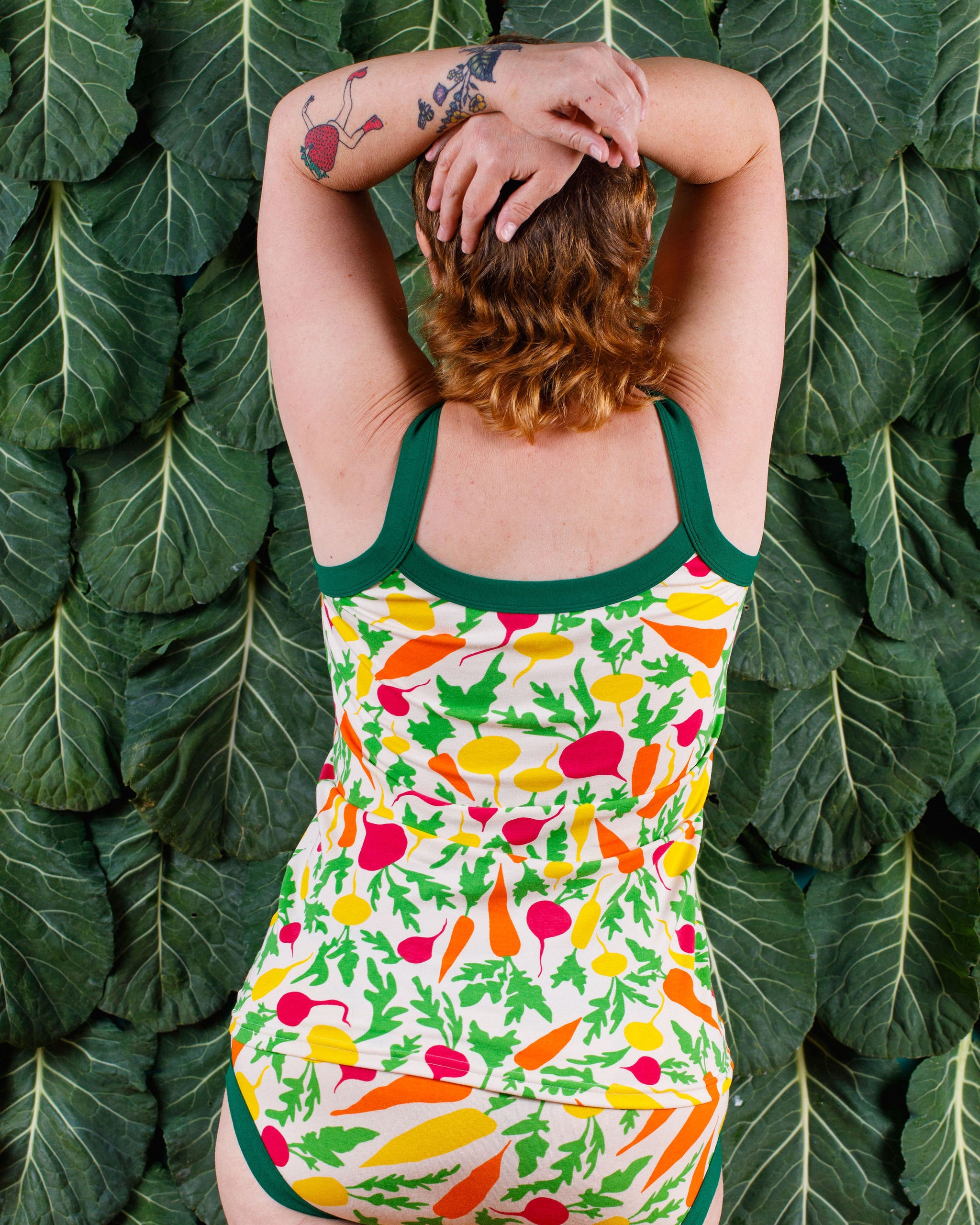 Back of model wearing Thunderants Camisole and Hipster style underwear in Root Veggies print - yellow, orange, pink, and green vegetables.