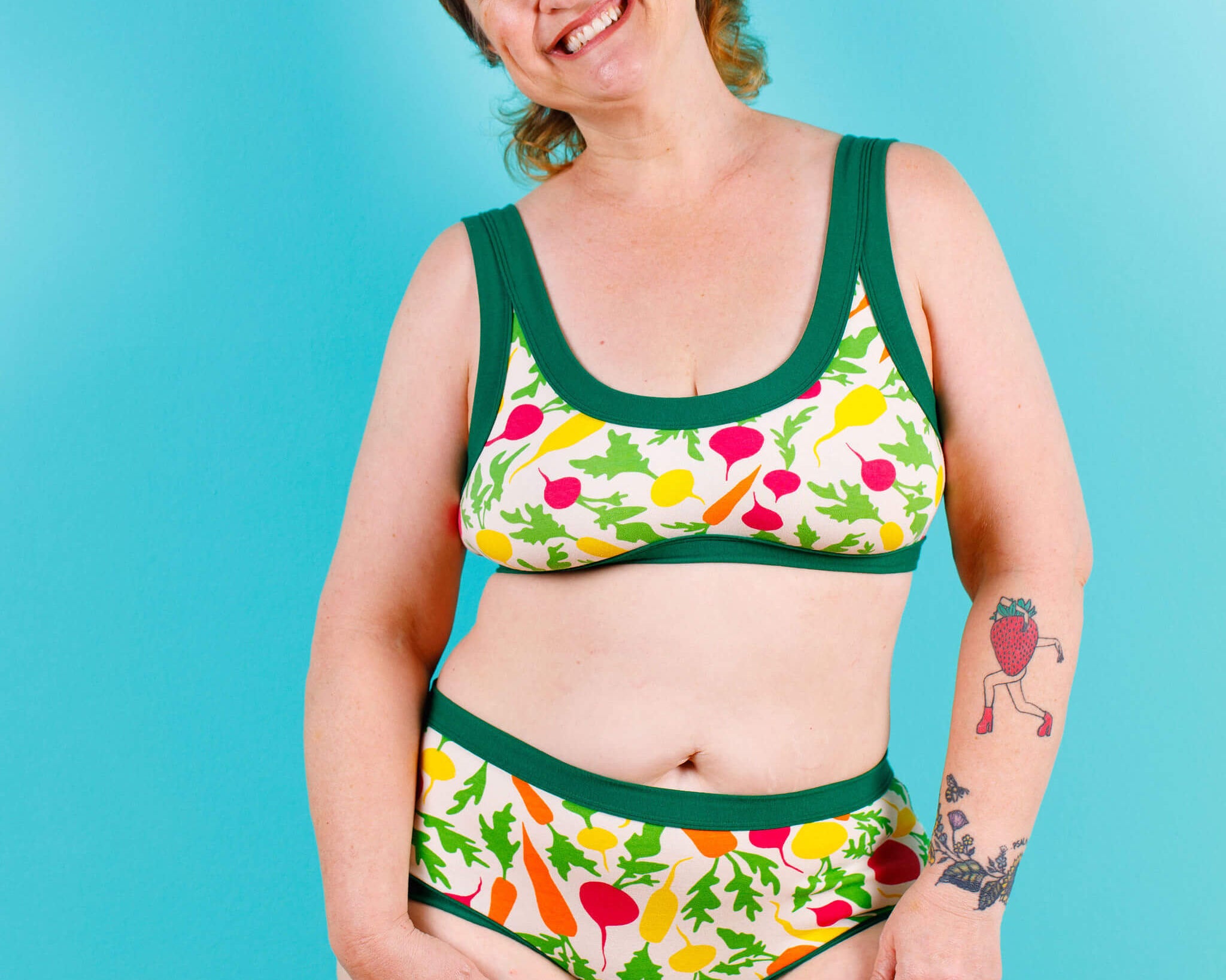 Model smiling wearing Thunderpants Bralette and Hipster style underwear in Root Veggies print.