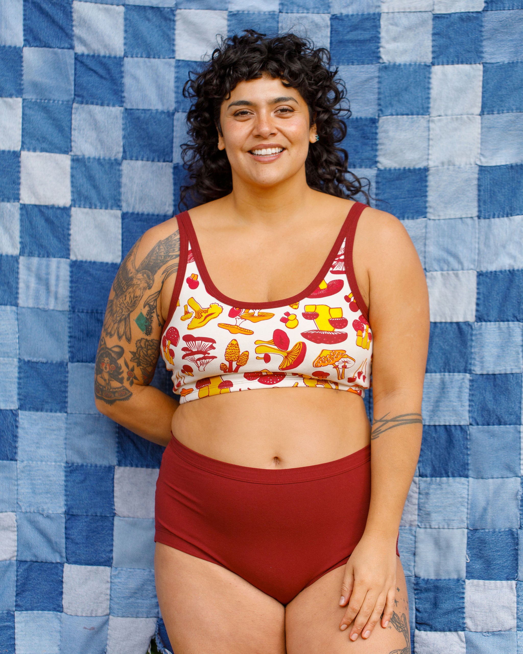 Model wearing Thunderpants Sky Rise style underwear in Cabern-YAY (a deep wine red color) and a Longline Bra in a mushroom print.