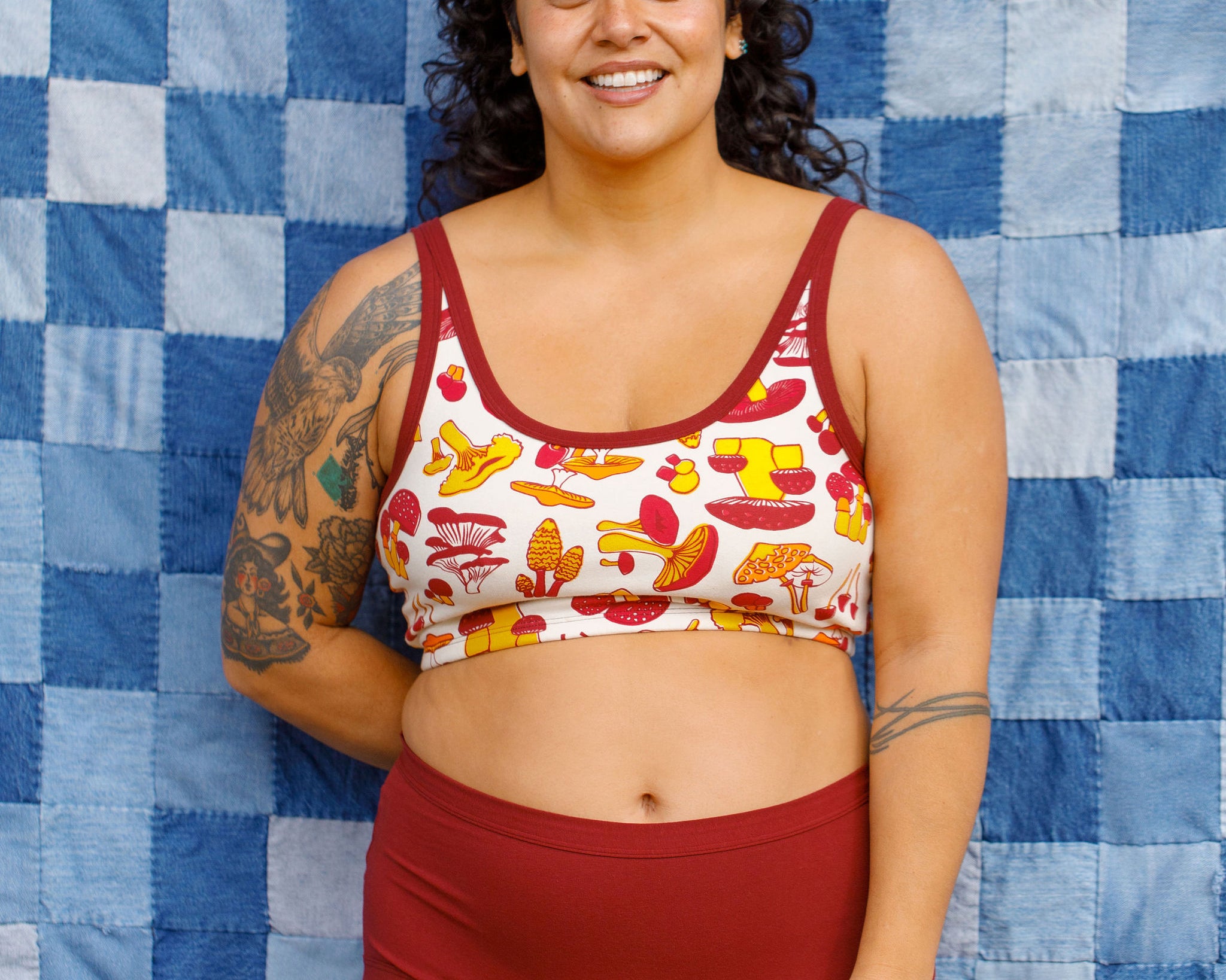 Model wearing Thunderpants Sky Rise style underwear in Cabern-YAY (a deep wine red color) and a Longline Bra in a mushroom print.