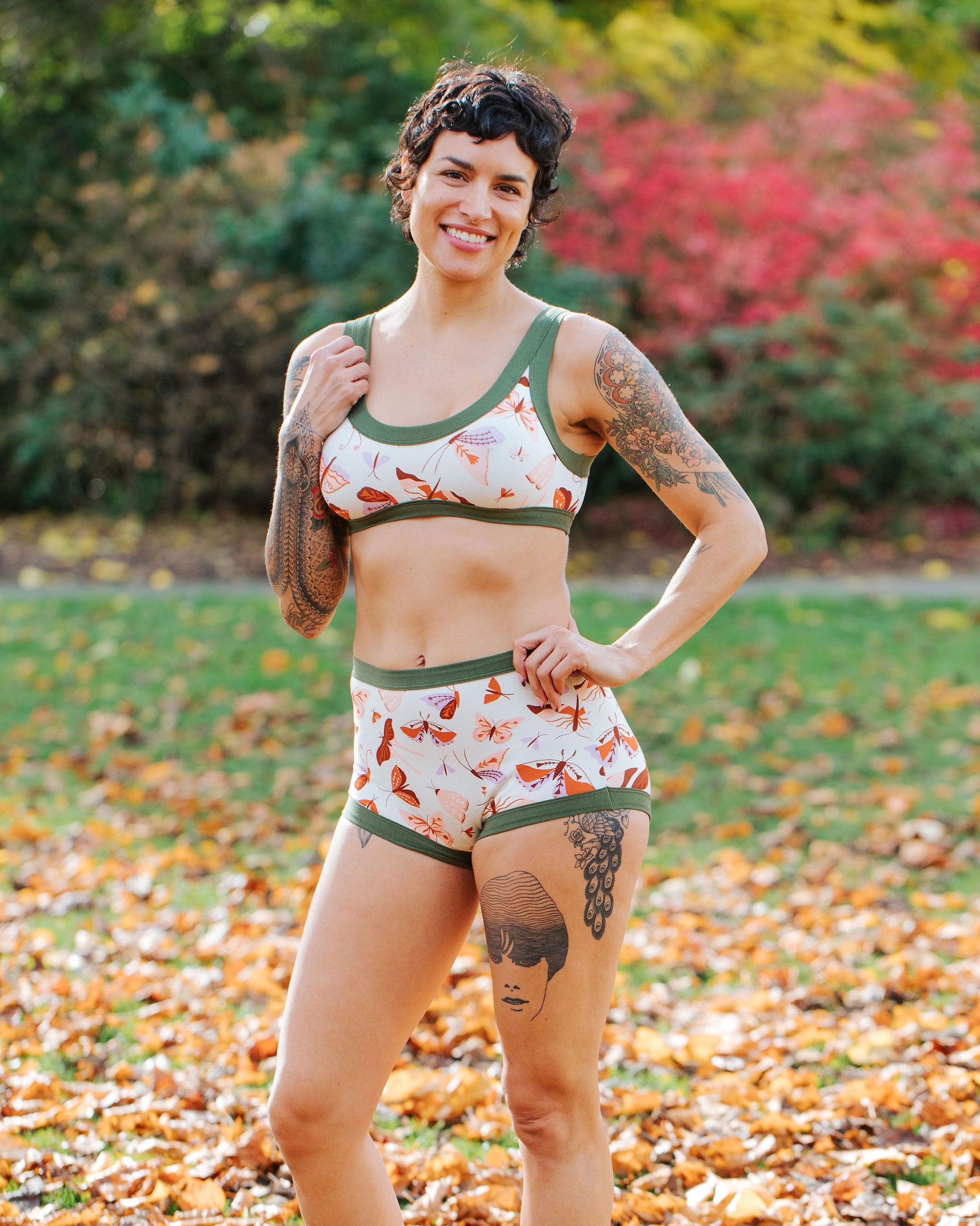 Model wearing Thunderpants Sky Rise style underwear and Bralette in Field Study: a moth print in red, orange, pink, and purple bound in green.