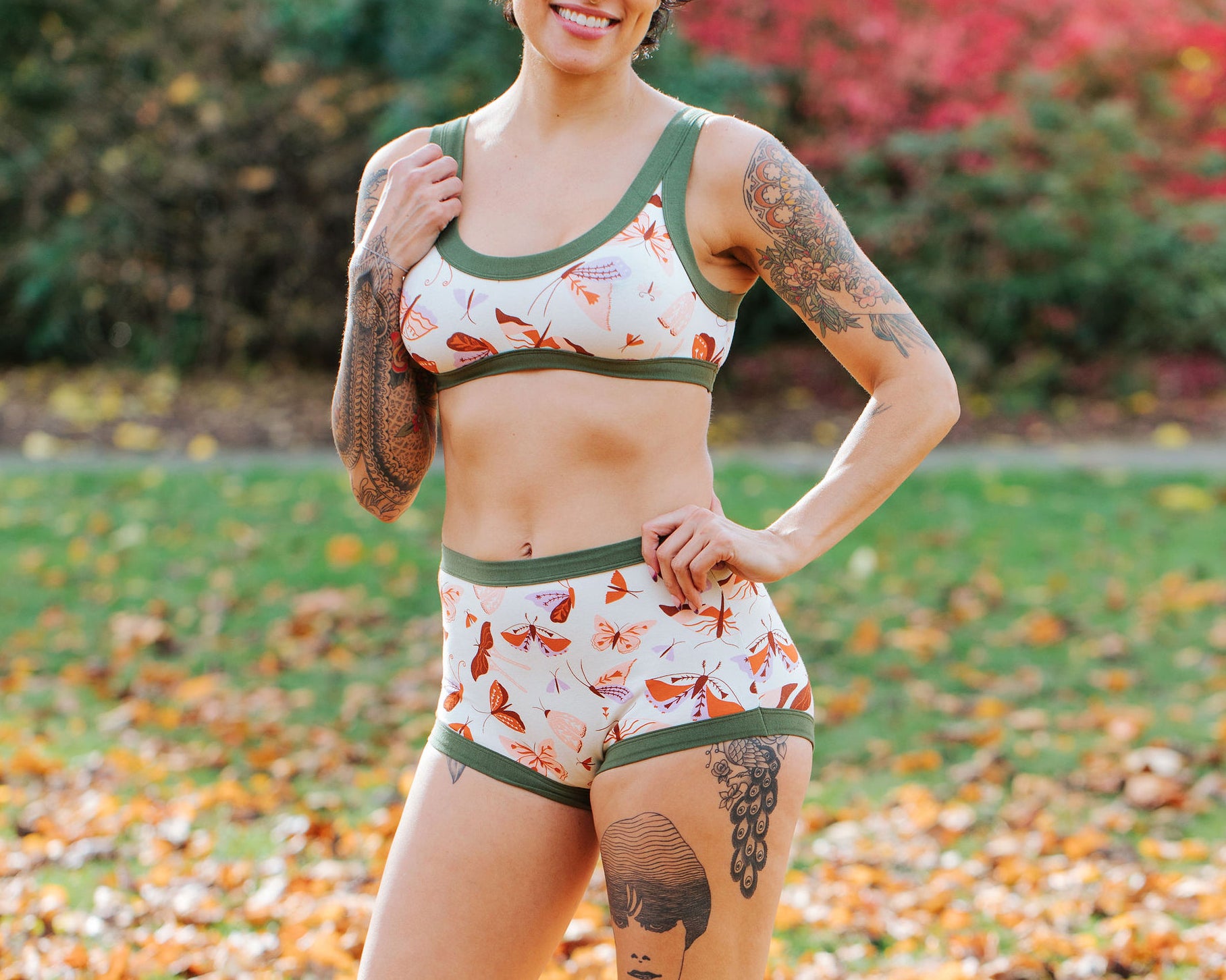 Model wearing Thunderpants Sky Rise style underwear and Bralette in Field Study: a moth print in red, orange, pink, and purple bound in green.