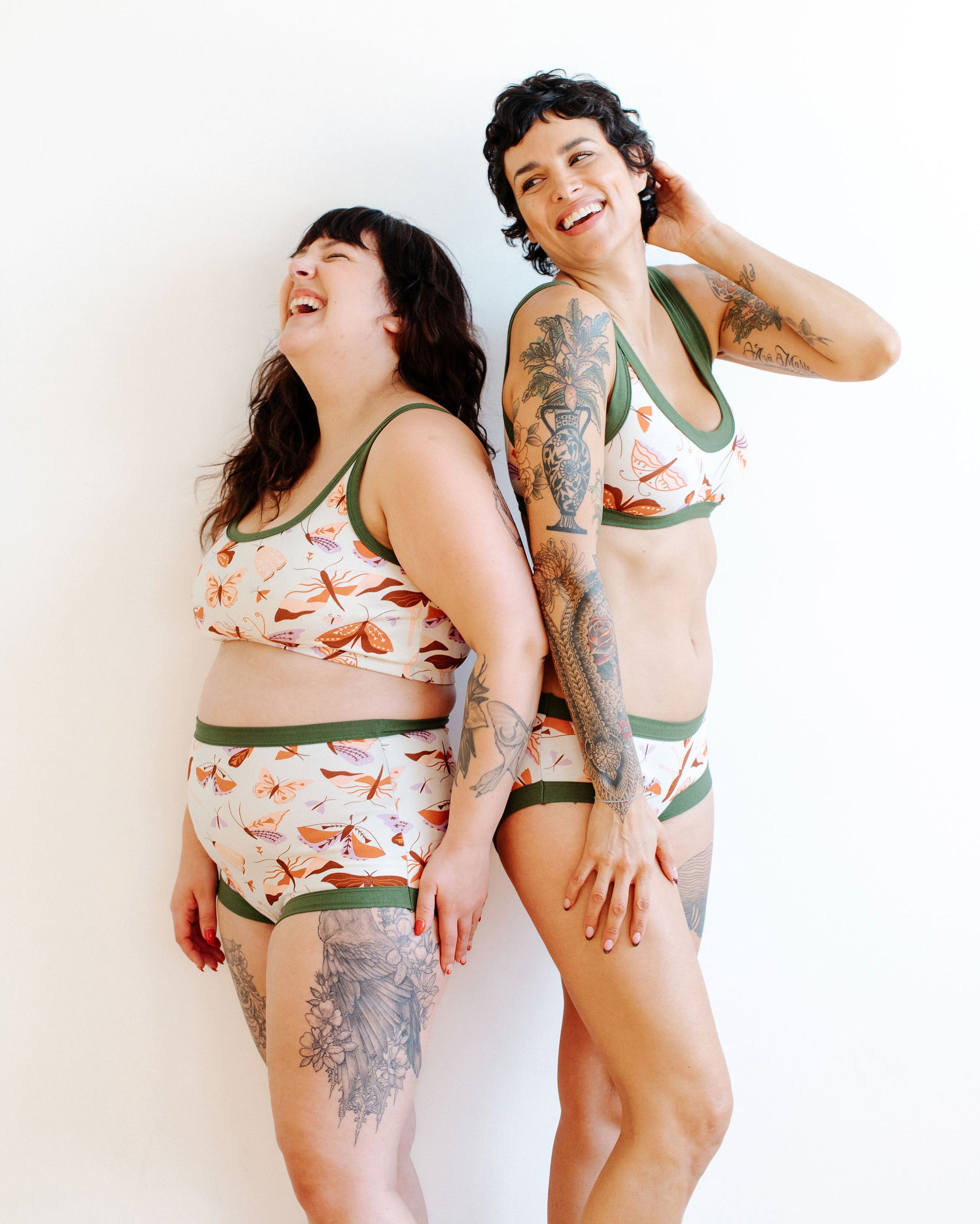 Model wearing Thunderpants Sky Rise style underwear and Longline Bra in Field Study: a moth print in red, orange, pink, and purple bound in green.