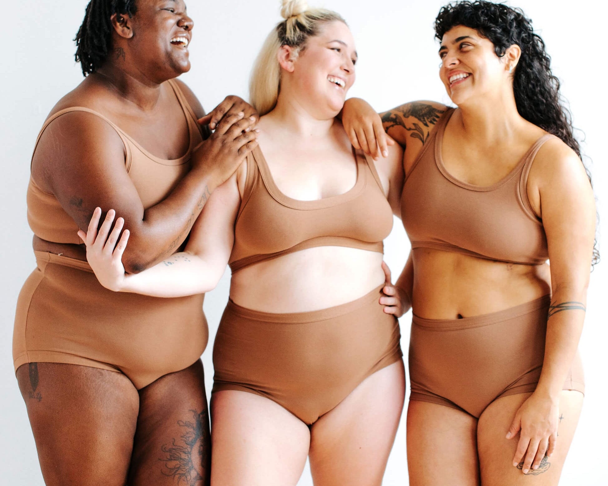 Three models wearing Thunderpants Sky Rise style underwear and longline bra in Hazelnut color.