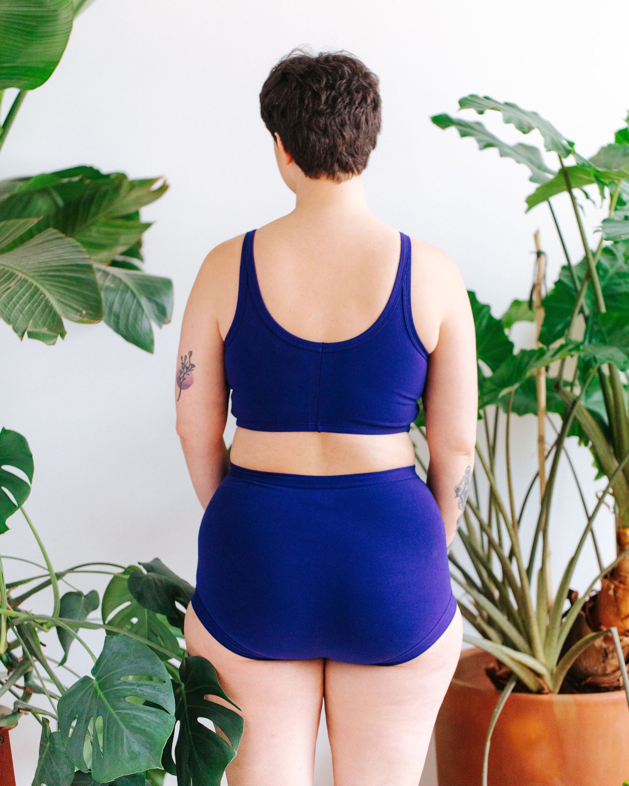 Model wearing Thunderpants Sky Rise style underwear and Longline Bra in Indigo blue.