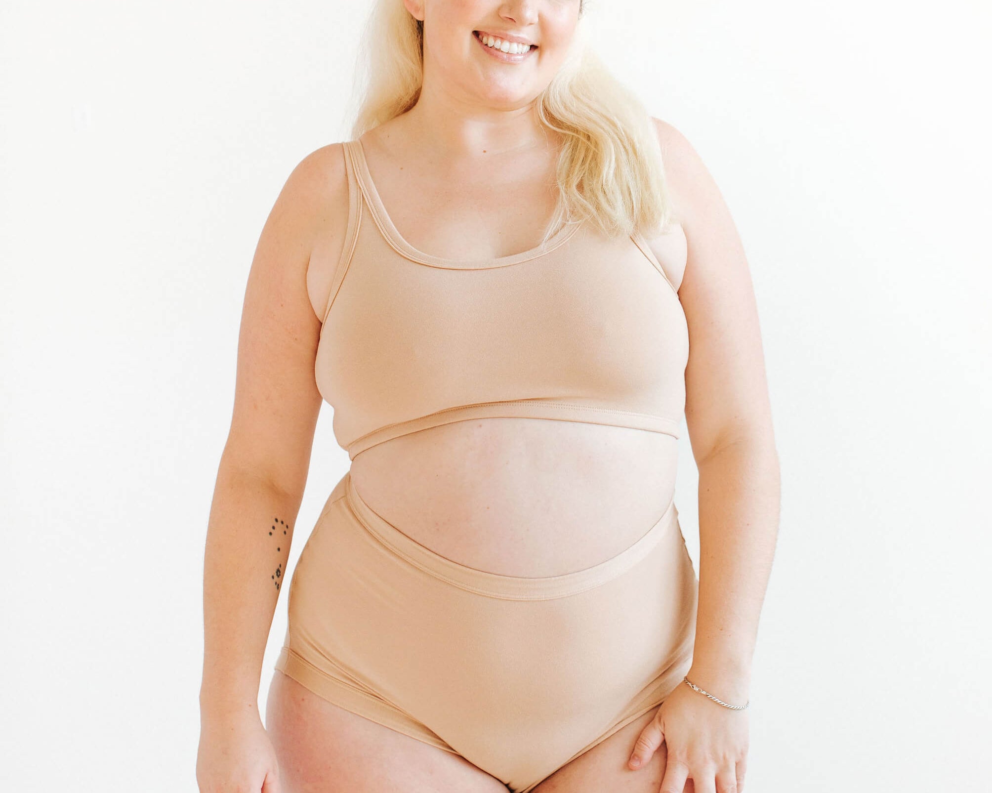 Model wearing Thunderpants Sky Rise style underwear and Longline Bra in Pine Nut - lighter tan color.