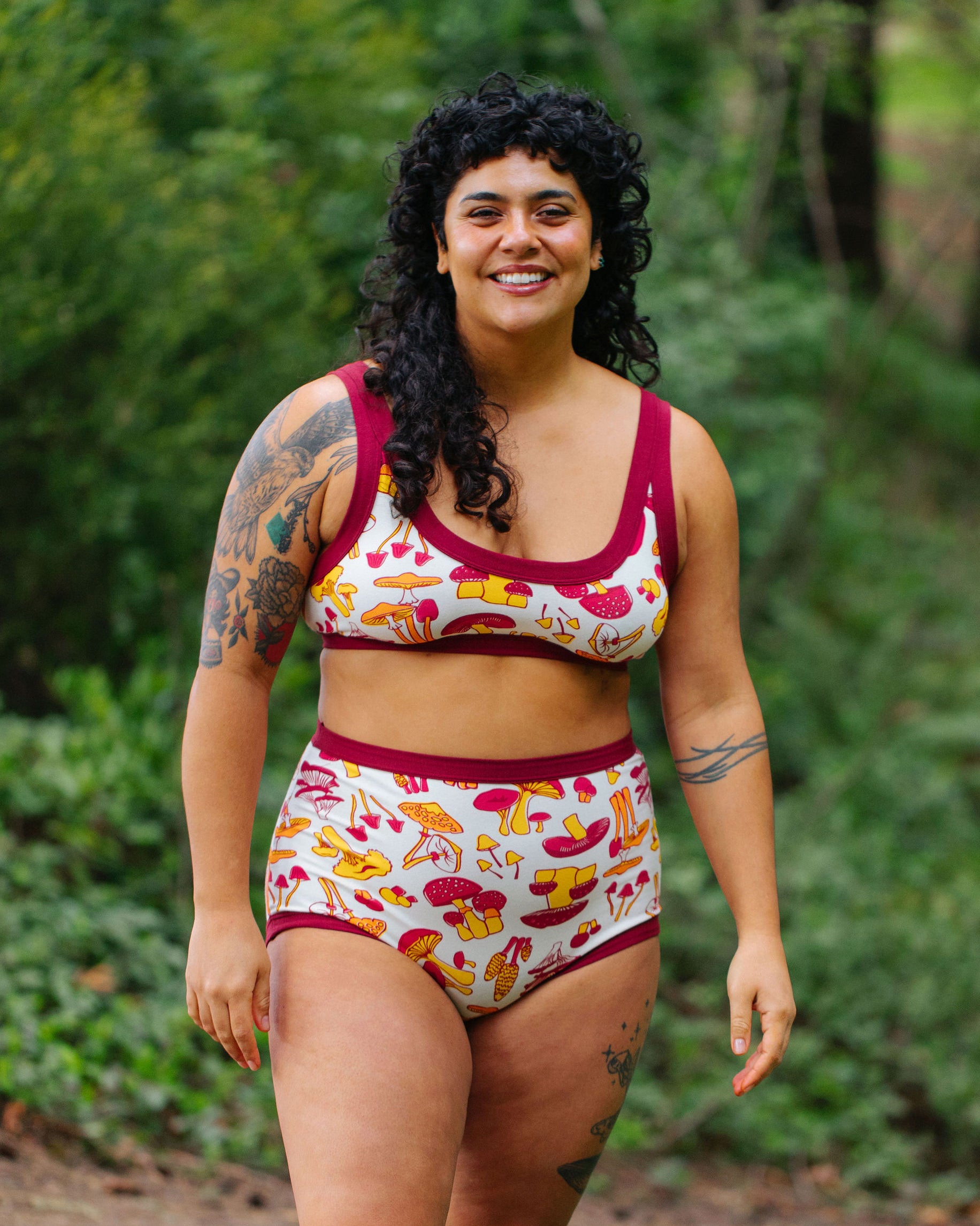 Model wearing Thunderpants Sky Rise style underwear and Bralette in Whadda Fungi print - red, yellow, and orange mushroom print.
